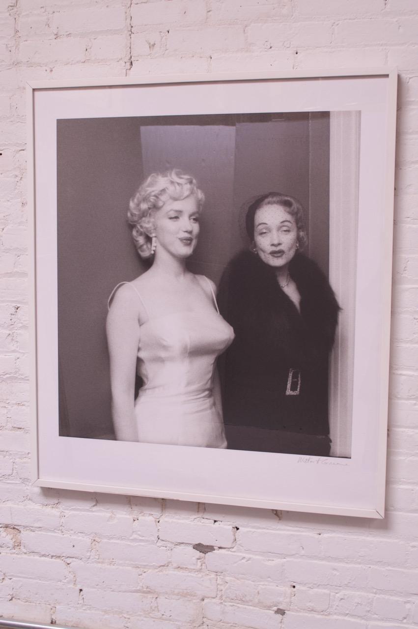 Digital print of Milton H. Greene's famous photograph of Marilyn Monroe and Marlene Dietrich. Greene, a friend to both Monroe and Dietrich, was responsible for introducing the two to each other in 1955.
Artist signed.
Retains the framer's tag