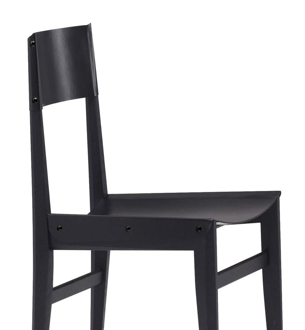 One part classic lines, one part punk chic, the Milvia leather dining chair is a timeless style with surprising detailing. On an ash frame, the chair features a leather seat and backrest, each attached to the frame by brass studs. Thanks to its