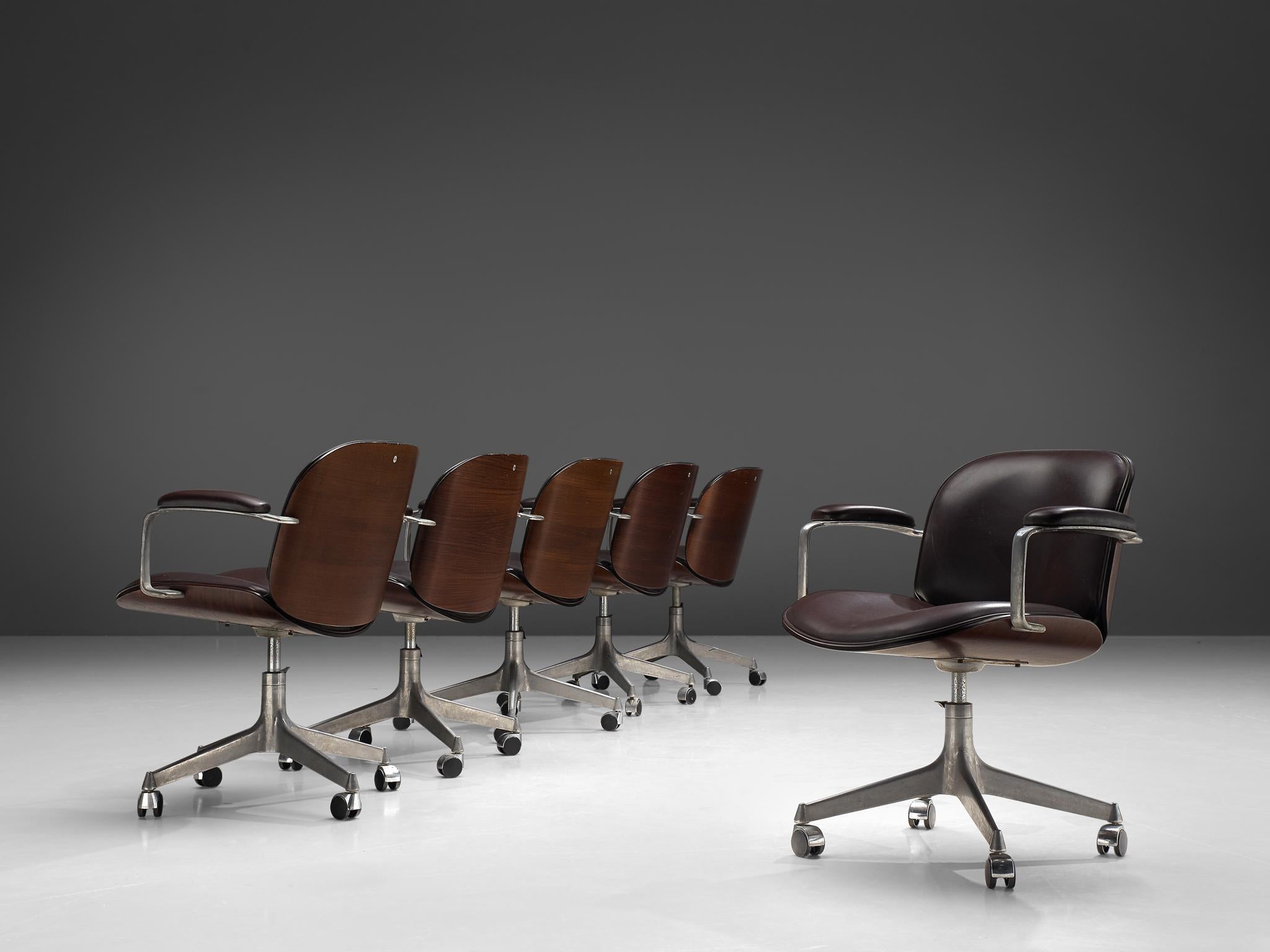 MIM Roma, set of six swivel desk chairs, rosewood, metal, brown faux leather, Italy, 1950s.

Set of six swivel office chairs from the 'Terni' series by MIM Roma. Seating and back are slightly curved and both halves are mirrored creating a vibrant