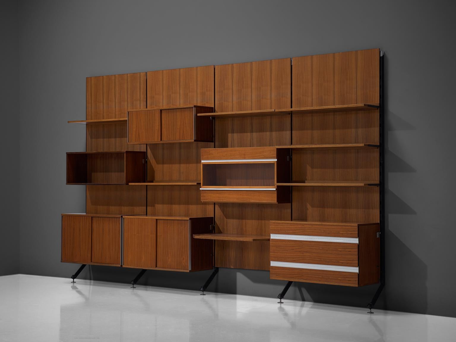 MIM Roma, cabinet, teak and aluminium, Italy, 1960s.

The monumental wall-mounted cabinet consists of four wall panels with various different storage facilities such as shelves, drawers and cabinet. The finish and details of this shelving wall