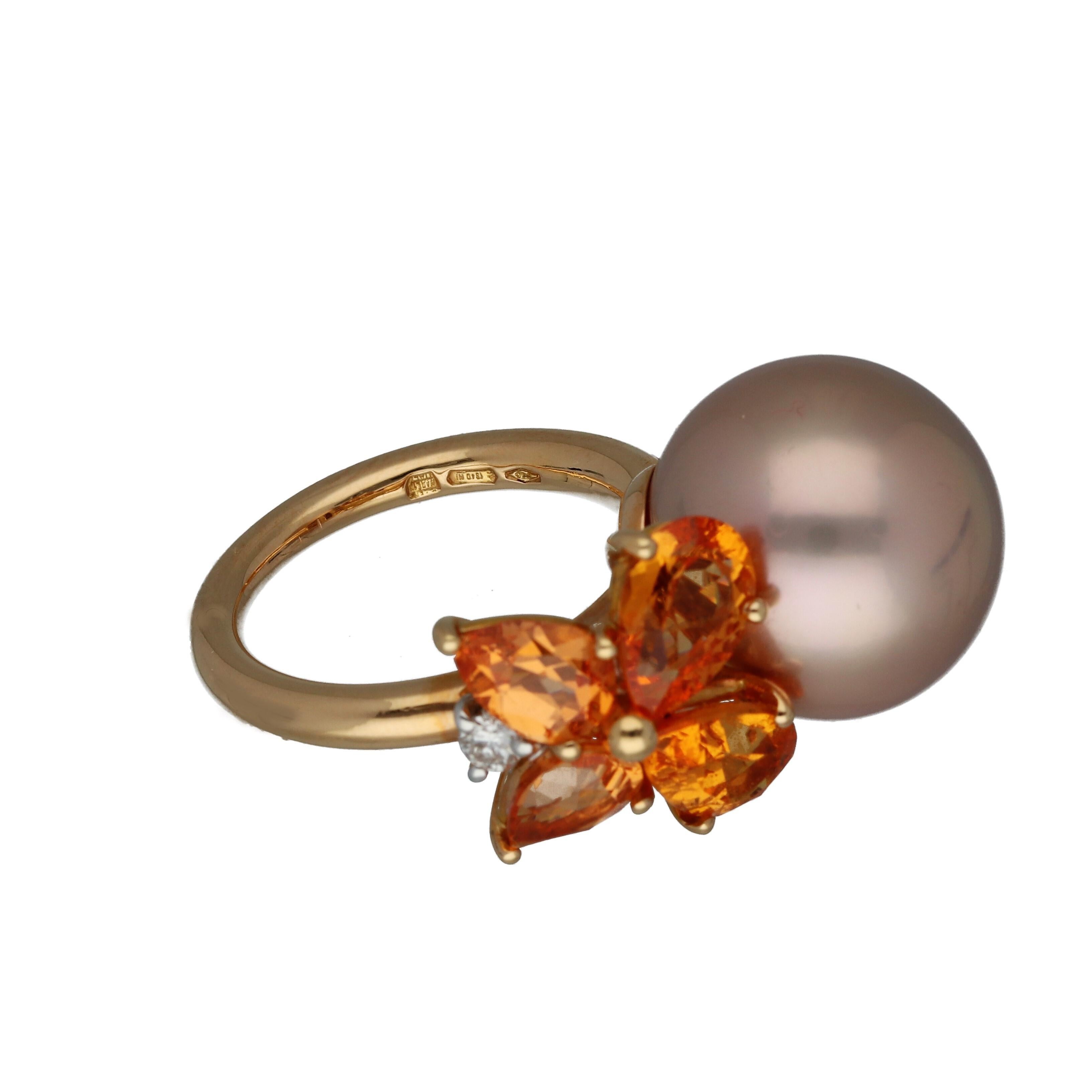 MiMI  18K Yellow Gold cocktail ring features a cultured pearl, a 0,15 ct round-cut diamond, and 4 mandarin garnets. 

RING SIZE US 6.75 - 53.8 mm

Mandarin Garnet has a captivating and intense orange color that recalls the glowing evening sky in