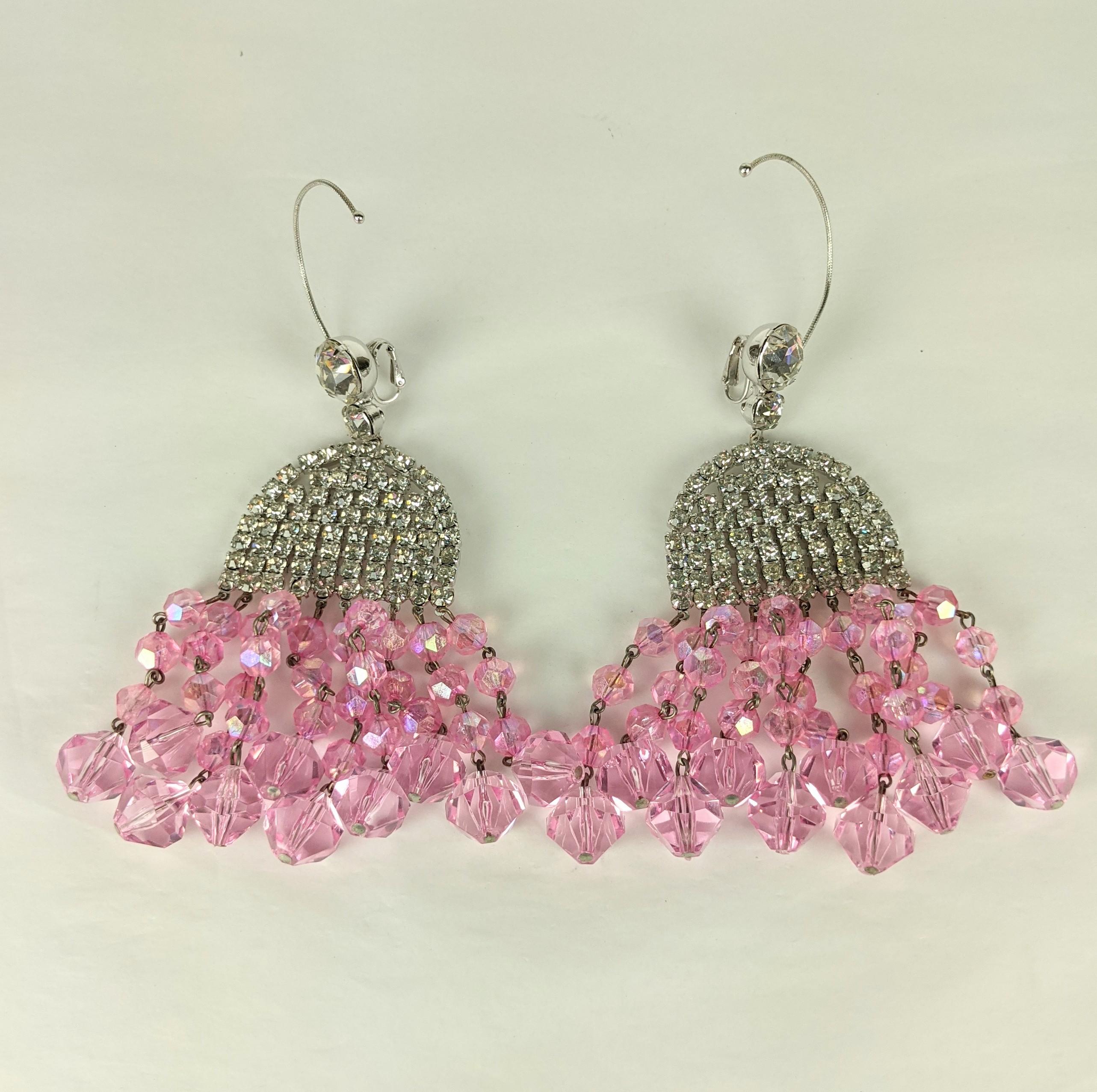 Rare and collectible Mimi di Nardo Massive 1960's Crystal and Pink Aurora Earrings with clip back fittings and ear hoops for support.  A large crystal decorates the ear with a pave half moon pendant with strands of graduated aurora borealis pink
