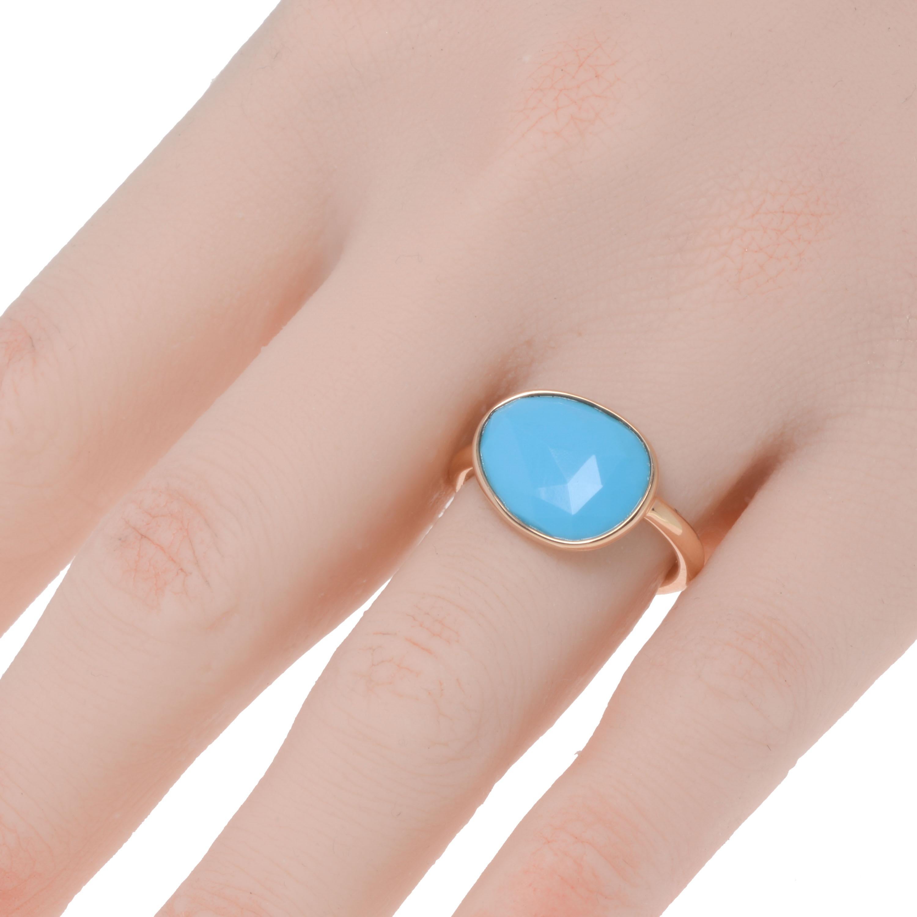 This contemporary Mimi Milano 18K rose gold cocktail ring features a faceted, asymmetrical turquoise framed in shiny 18K rose gold on a thin band. The ring size is 6.75. The decoration size is 5/8