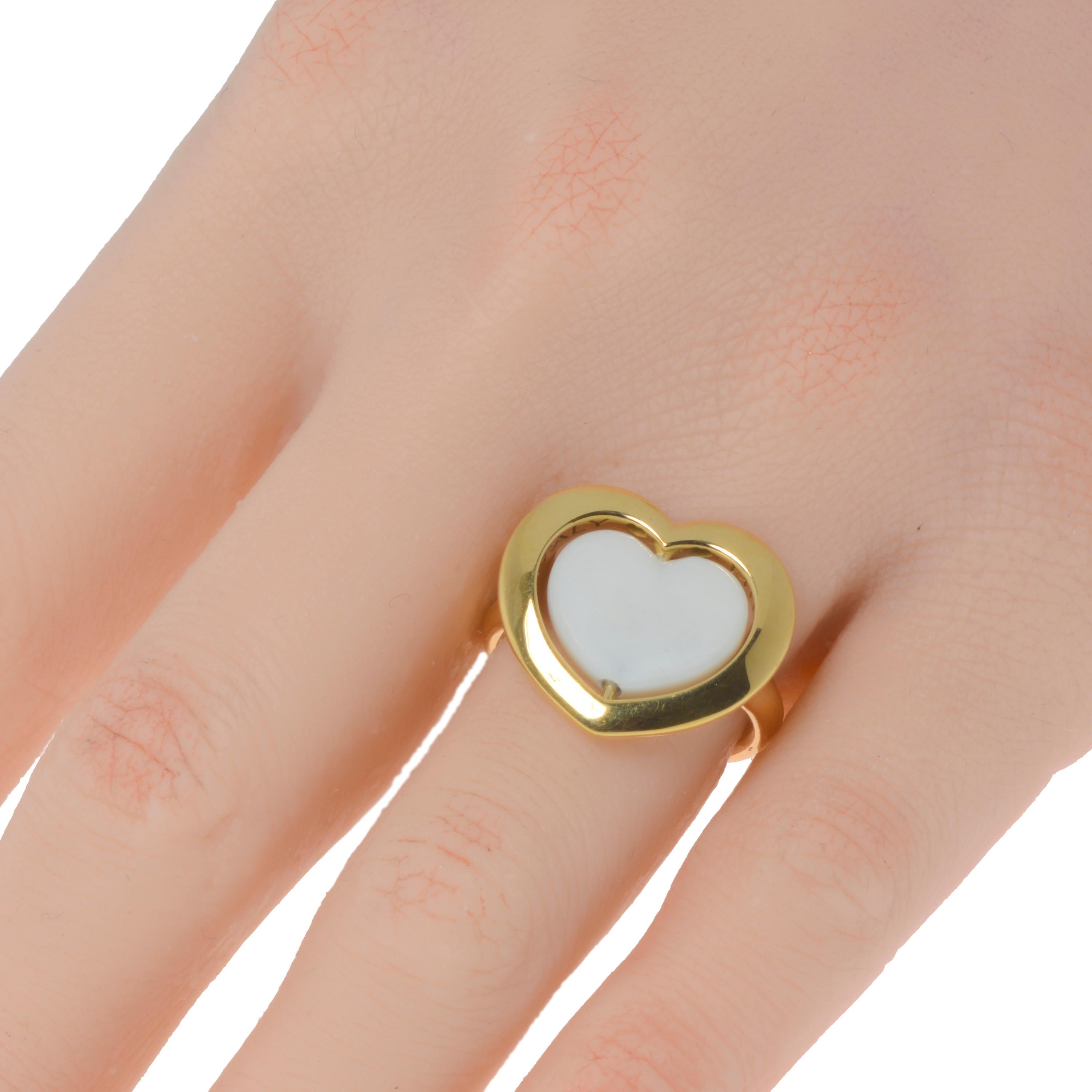 Mimi Milano 18K yellow gold cocktail ring features a convex white quartzite heart which can be rotated to reveal a yellow gold side that matches a shiny 18K yellow gold frame and band. The ring size is 6.75. The decoration size is 3/4