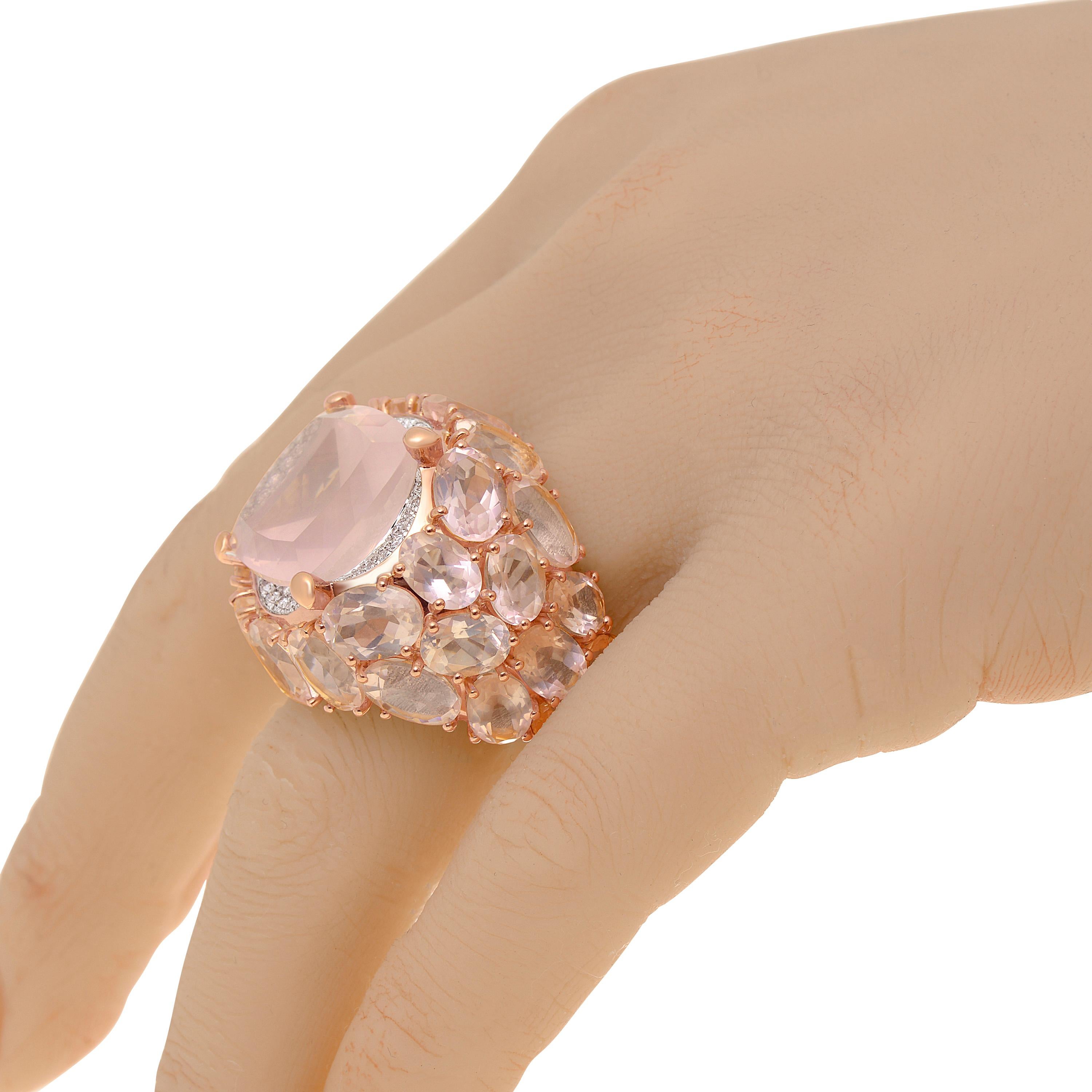 This bejeweled Mimi Milano 18K rose gold statement ring features Rose Quartz and 0.44ct. tw. diamonds set in 18K rose gold. The ring size is 7.25 (54). The band width is 3/8