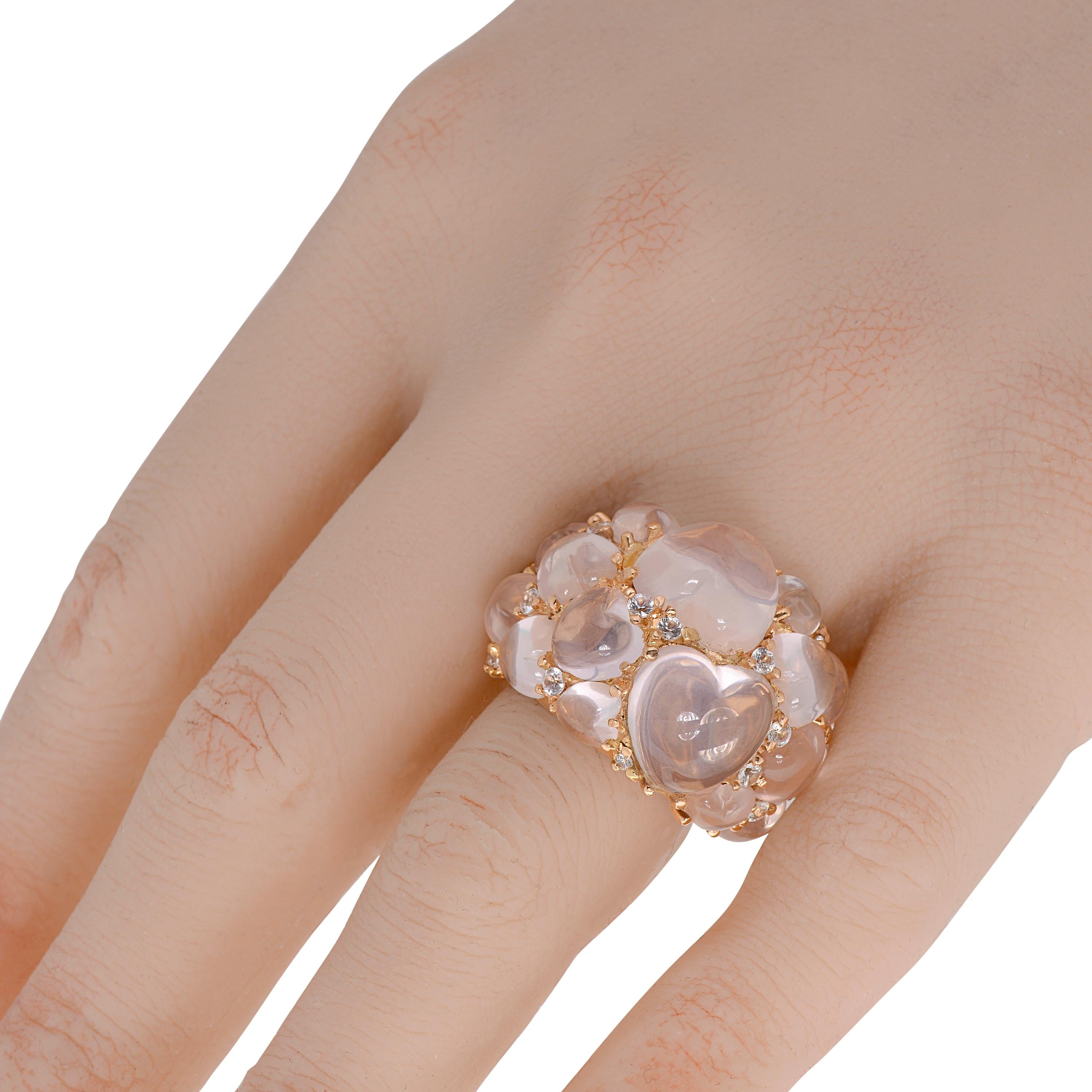 Mimi Milano 18K rose gold cocktail ring features shimmering prong set 0.75ct. tw. sapphire adorning 20.96ct. tw. cabochon pink quartz hearts. The ring size is 7.75. The band width is 1/4