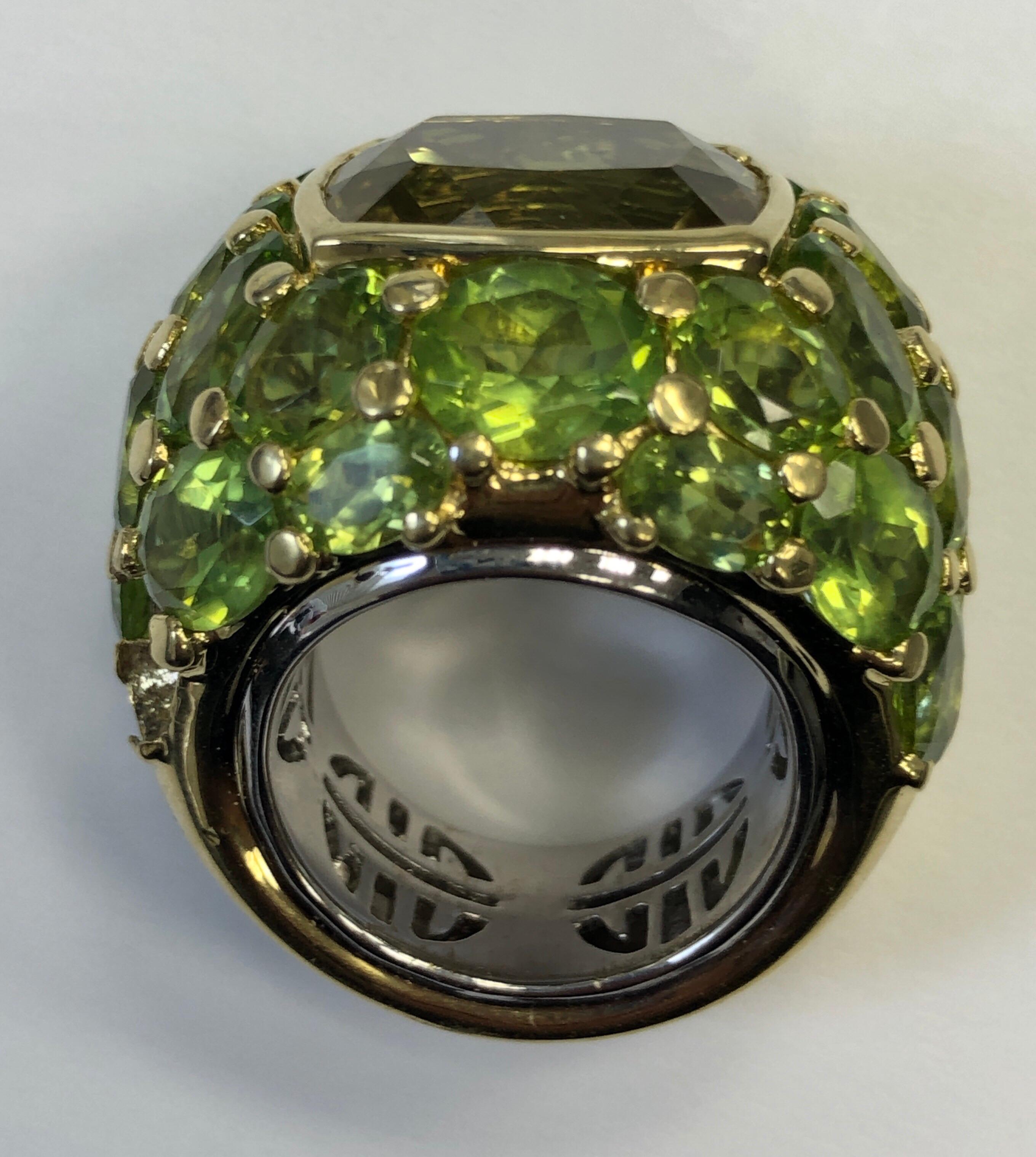 The ring, sized 7.75, is absolutely huge and fabulous. Centered on an approximately 16 carat lemon quartz and surrounded by approximately 32 carats of fine oval mixed cut peridot, and weighing a hefty 42.50 grams this is quite the cocktail ring. New