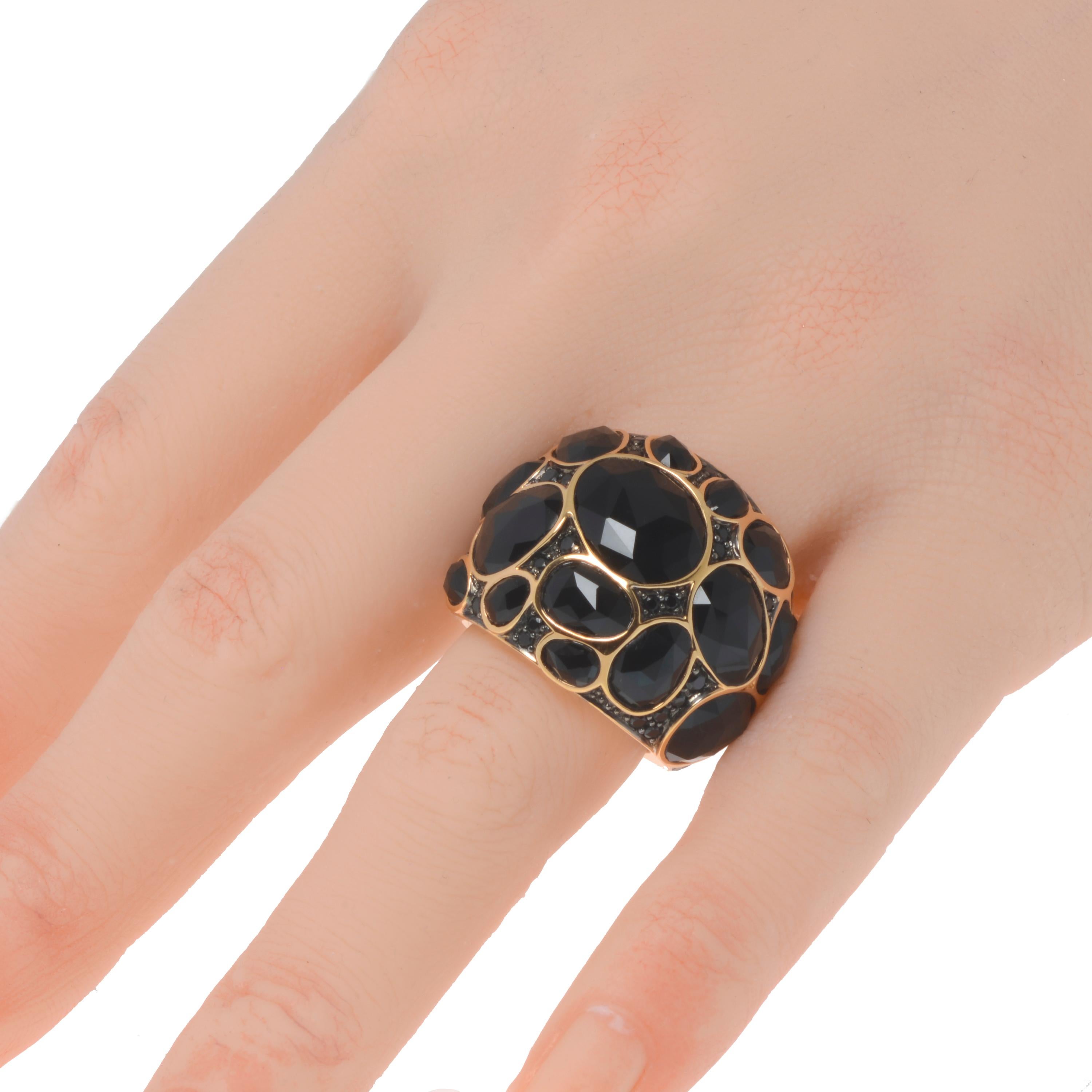 This dazzling Mimi Milano 18K Rose Gold cocktail Ring features an eye-catching mix of faceted agate and sparkling black spinel in wide domed band set in 18K rose gold. The ring size is 6.25. The Band Width is 22.7mm. The Weight is 23g. This designer