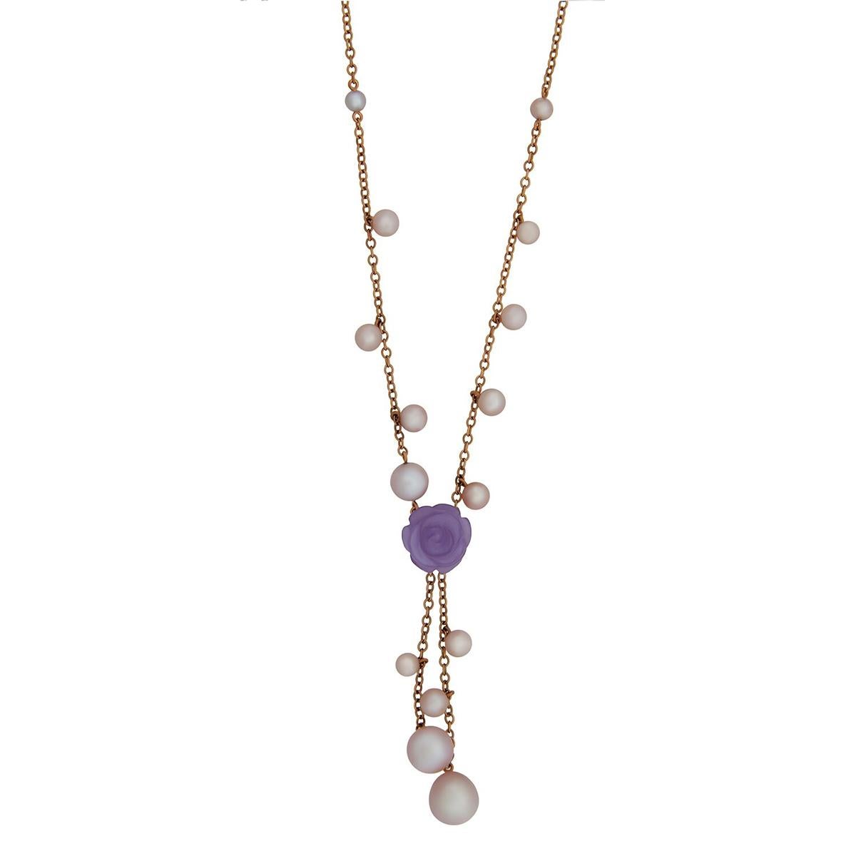 A chic necklace by Mimi Milano featuring a 8.25ct lavender jade cut in the shape o a flower surrounded by violet cultured freshwater pearls in 18k rose gold.