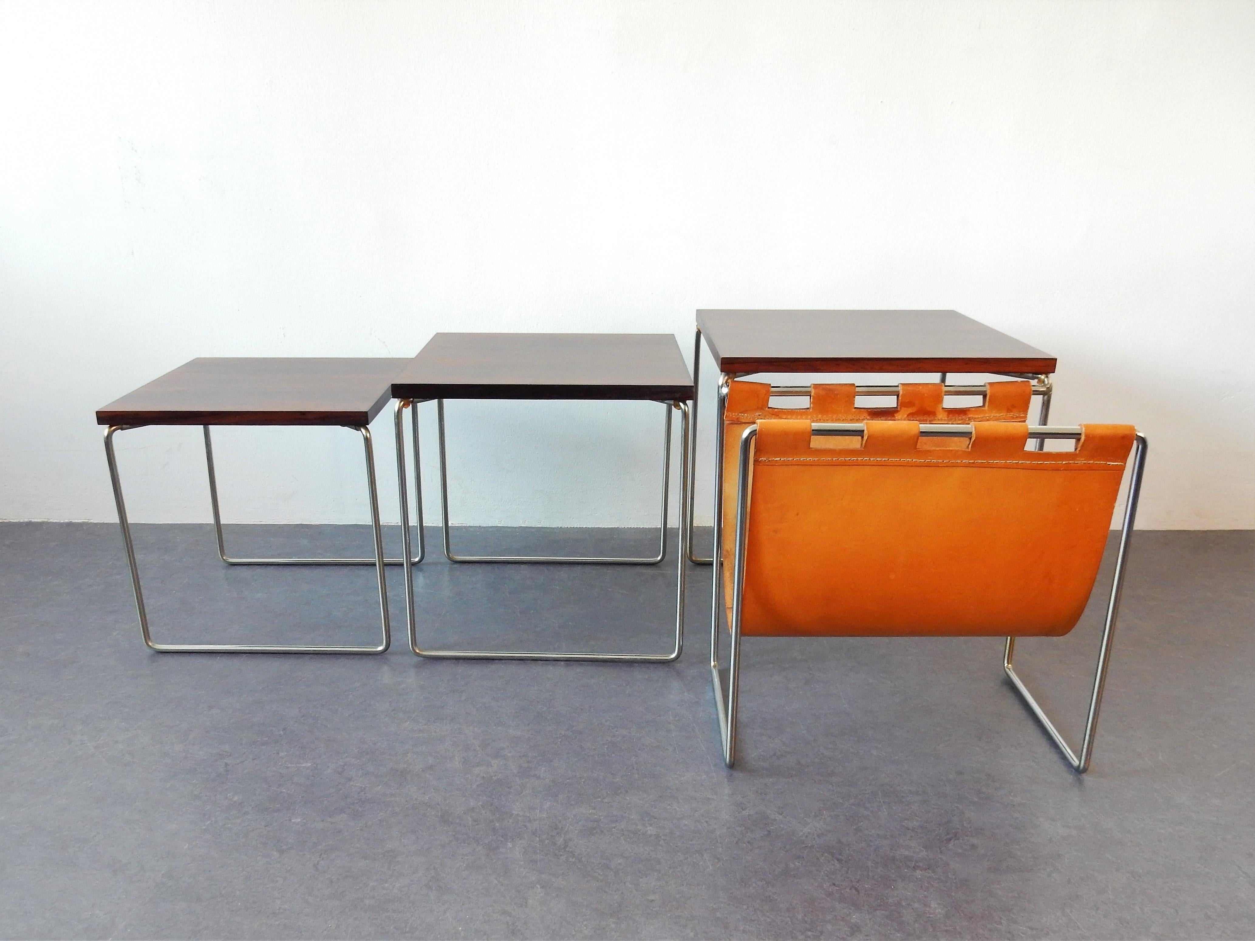 This nice set of three nesting tables was made by Brabantia in the 1960s. The tables have a square chrome base with a rosewood top. The leather magazine holder that is attached to the biggest table makes it complete and stunning! This set has been
