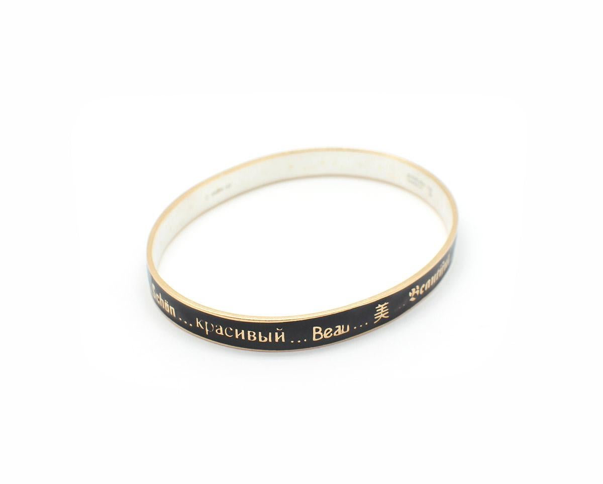 This limited edition ‘beautiful’ bangle bracelet is made in 18k yellow gold with Sterling silver. This bracelet by designer Mimi So is with black enamel with the word ‘beautiful’ in 8 different languages repeating around the bangle. The bracelet