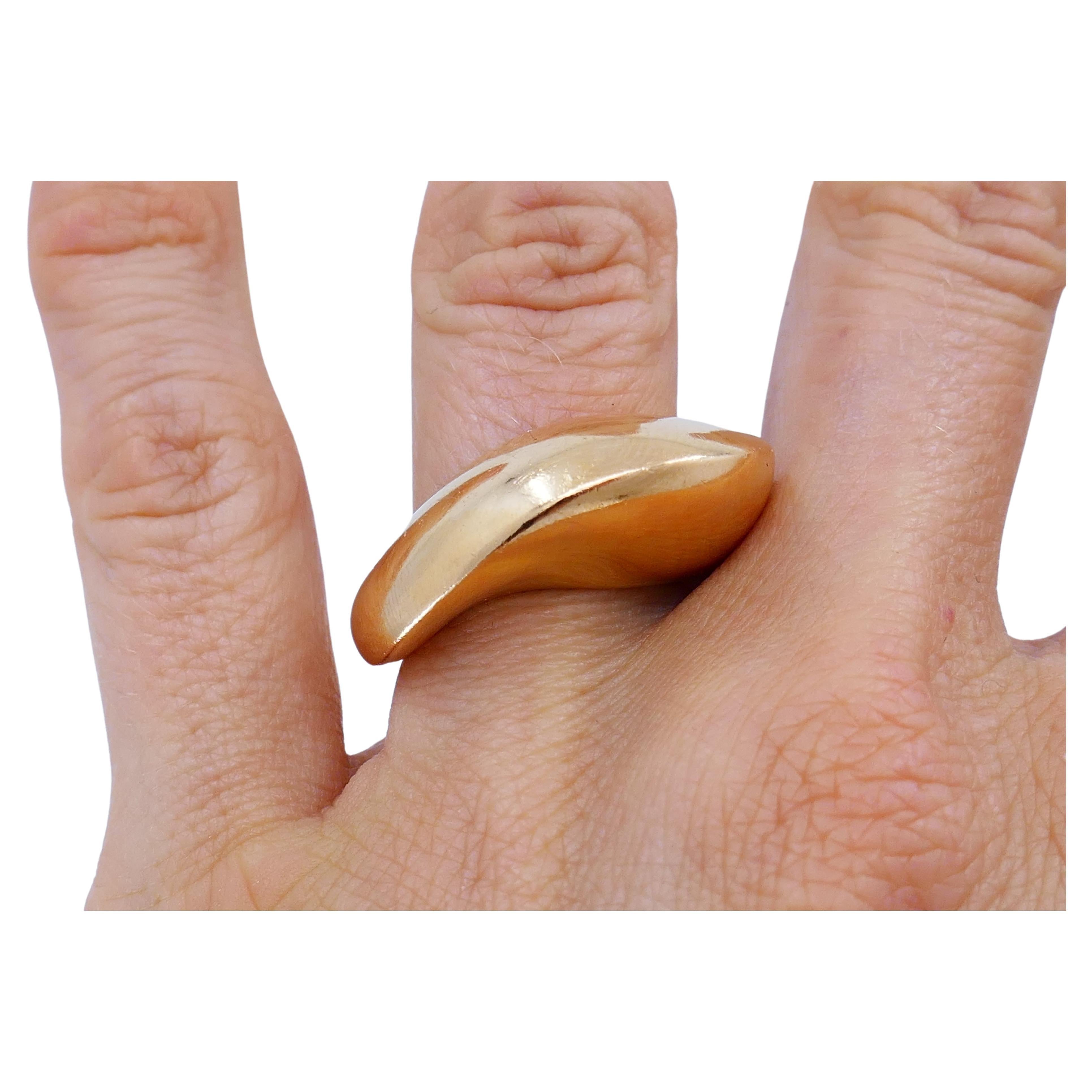 An abstract shape 18k gold Mimi So band ring. 
The ring has amazingly smooth lines that is reminiscent of a Ying Yang symbol. The symbol itself is placed in the back of the front part. The gold has a silky feel because of the beautiful shimmering