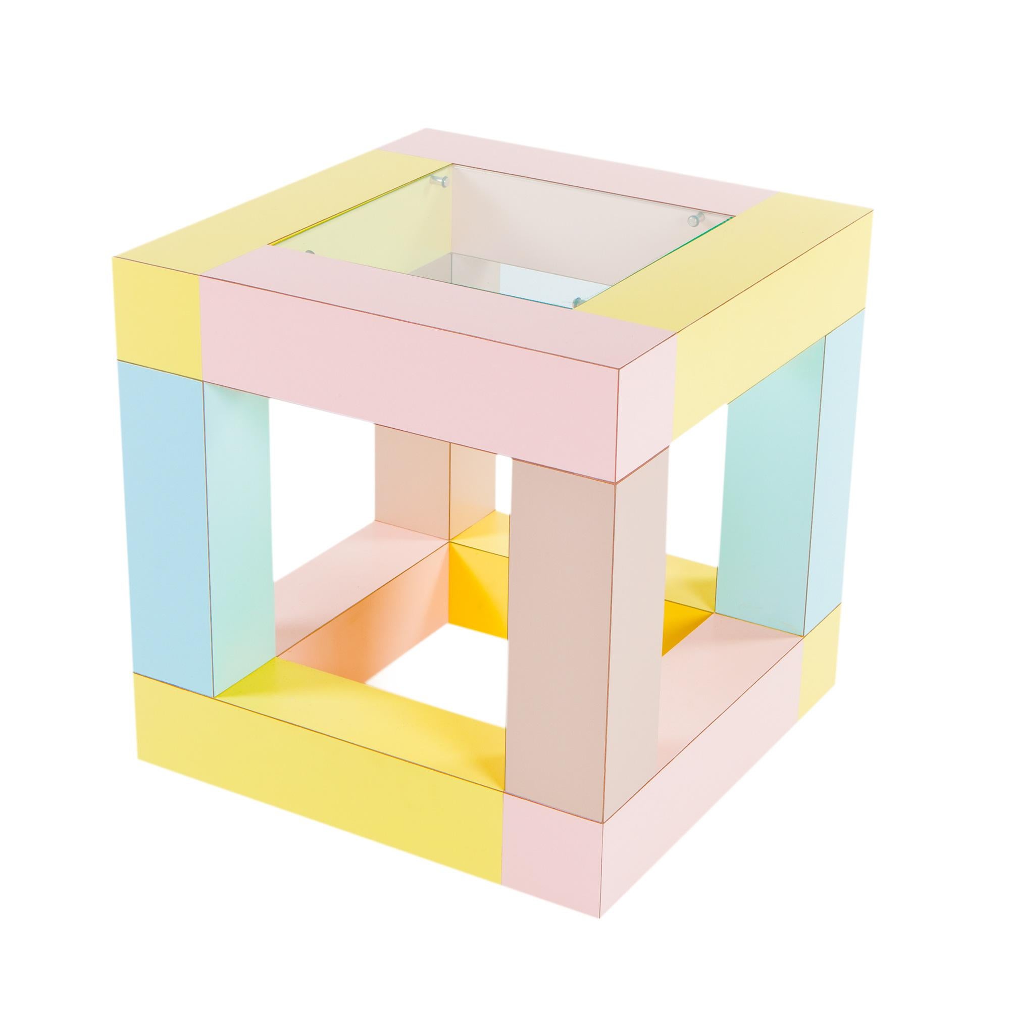 A multi-use, highly-functional end table by Ettore Sottsass for Memphis (1984). The top possesses a small inserted piece of tempered glass, otherwise leaving the piece to visually remain a perfect cube (overtones of Sol LeWitt a la Sottsass).
The