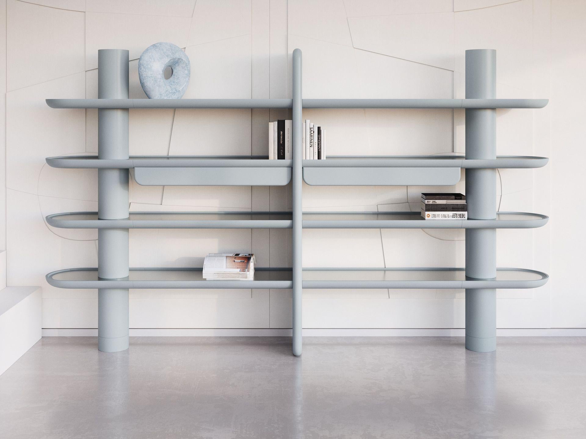 Harmonious proportions and gentle curves characterise10 this sophisticated bookcase, its wide four shelves sustained by the combination of a central vertical panel and two cylindrical side columns. Offered in a delicate tone of pastel light-blue,