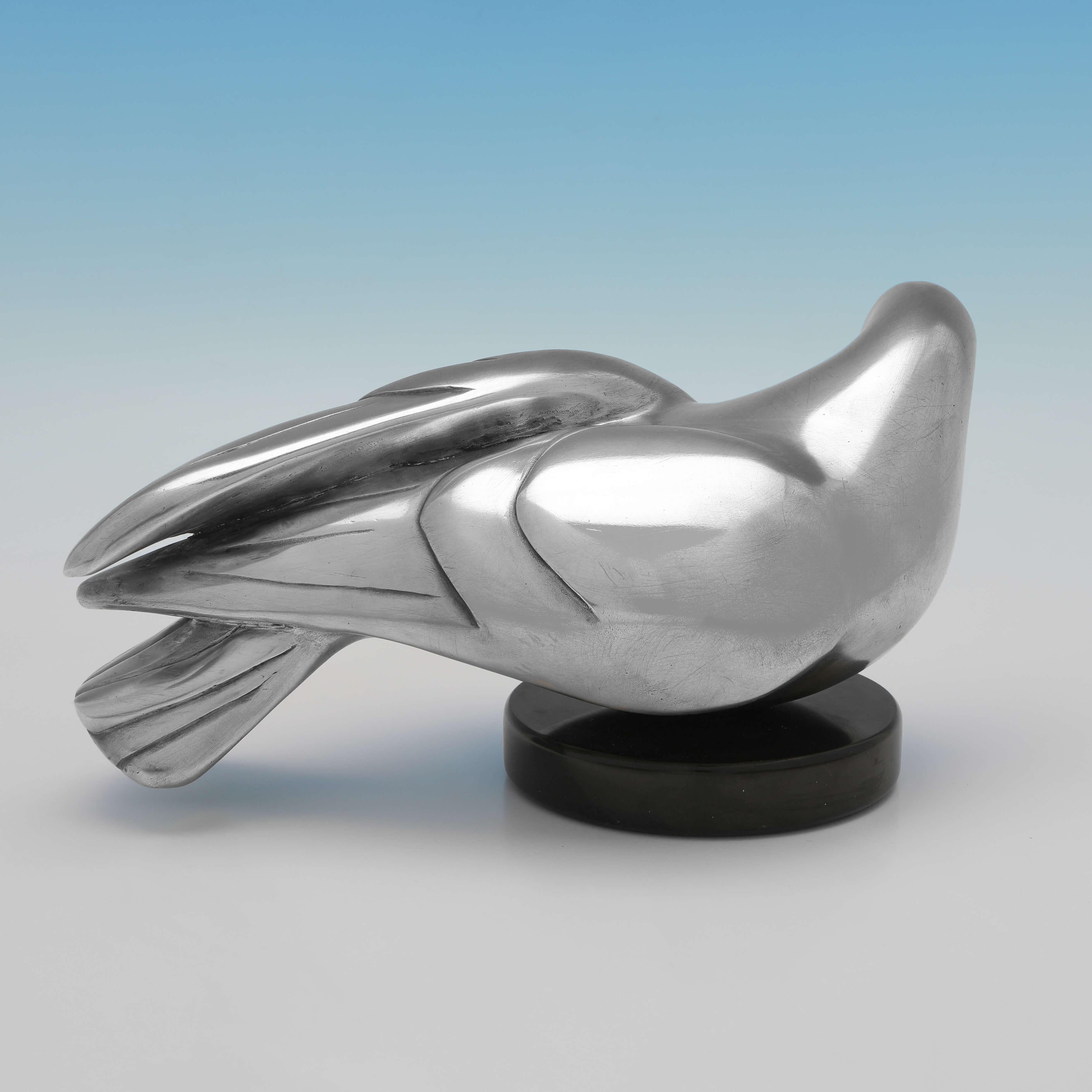 This interesting sculptural representation of a dove carries hallmarks for London in 1999, and the makers mark for the Morris Singer Foundry. 

The dove is number 2 of a limited edition of 25 manufactured in sterling silver, designed by Mina