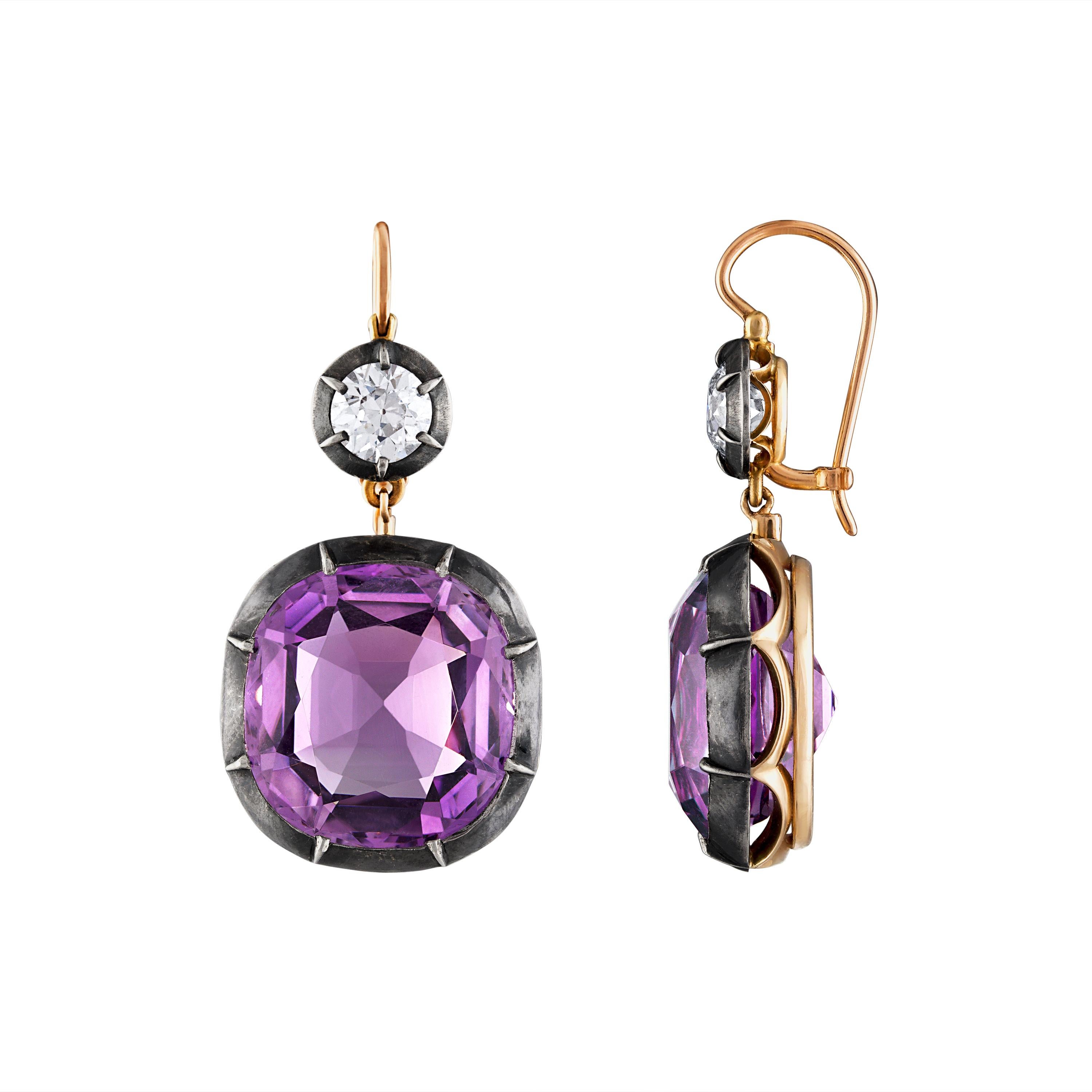 2 large custom antique cut Amethysts and 2 old mine diamonds, approximately 1.60 CTW Diamonds and 32 CTW Amethyst set in a collet Silver-topped Gold mounting.

1-1/2 inch long and 3/4 inch wide.