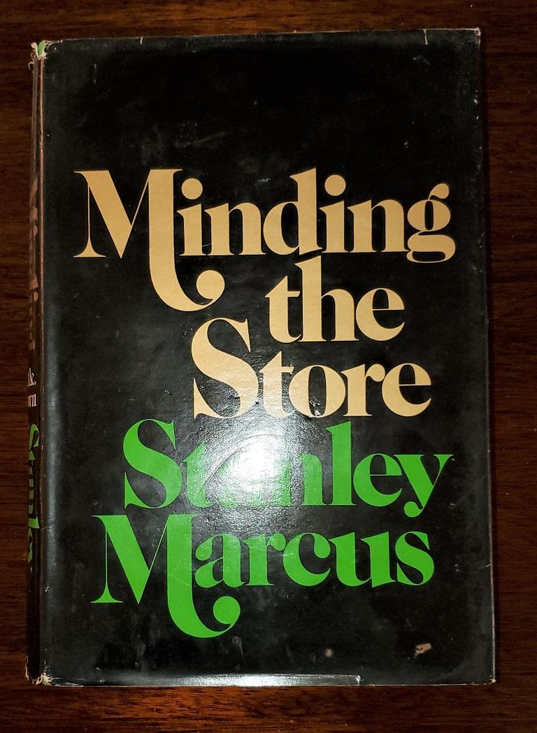 Presenting a signed first edition of ‘Minding the Store’ a memoir by Stanley Marcus.

Published by Little, Brown (1974).

First edition second printing. Pages 383.

Dust cover in fair condition, some minor scuffing and repaired tear to back.
