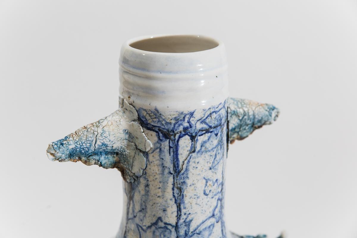 Mindy Horn’s non-functional vessels, purposely thrown off center, appear to have grown and weathered organically. The surfaces of the vessels, crusty or cracked, emphasize their crooked, uneven forms. While their appearance seems to contradict