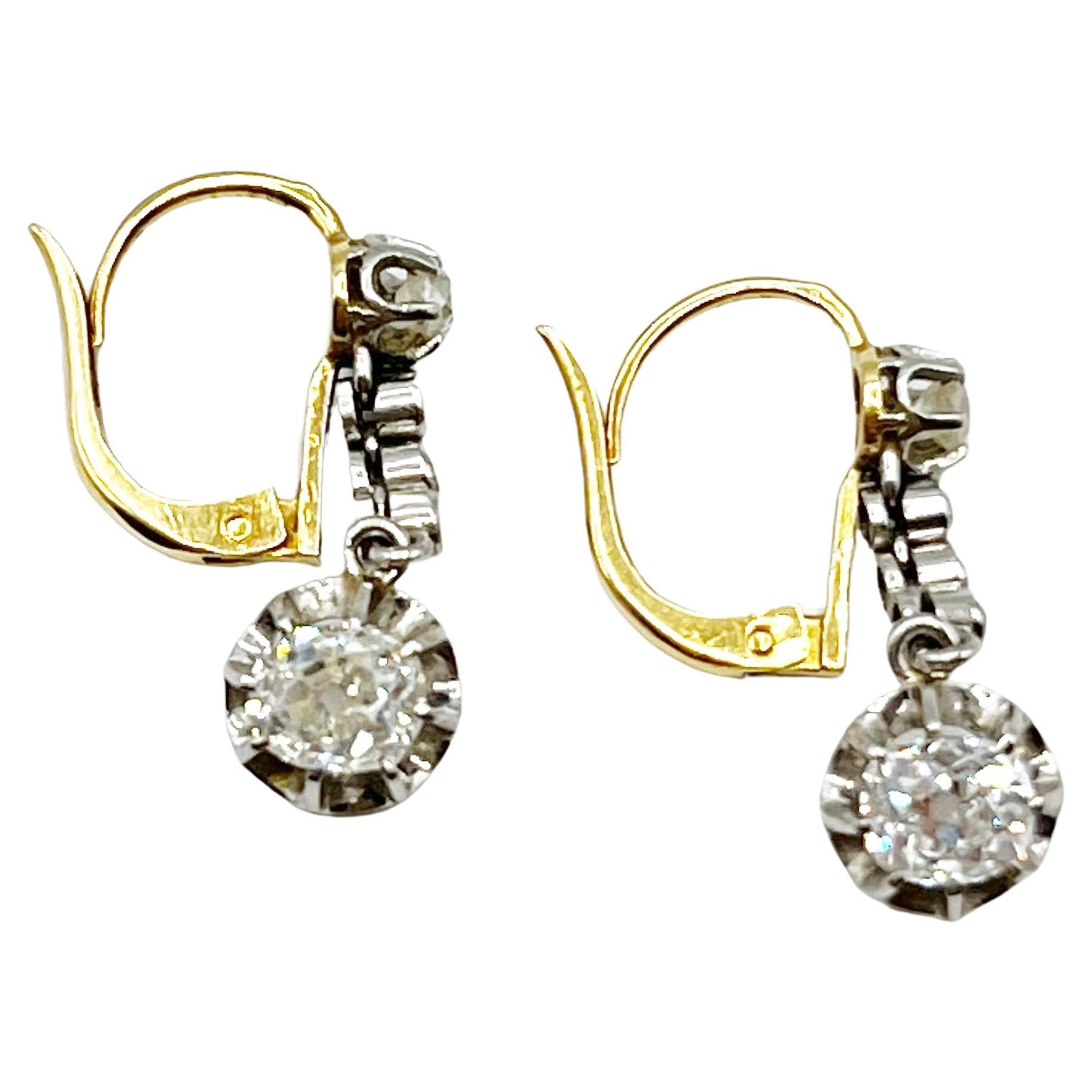 These stunning diamond earrings are classic and timeless. The length is perfect for an elegant night out or to wear for every day dressing. The two diamonds on the bottom of the earrings equal 1.7 + carats. All of the diamonds are Old Mine Cut and