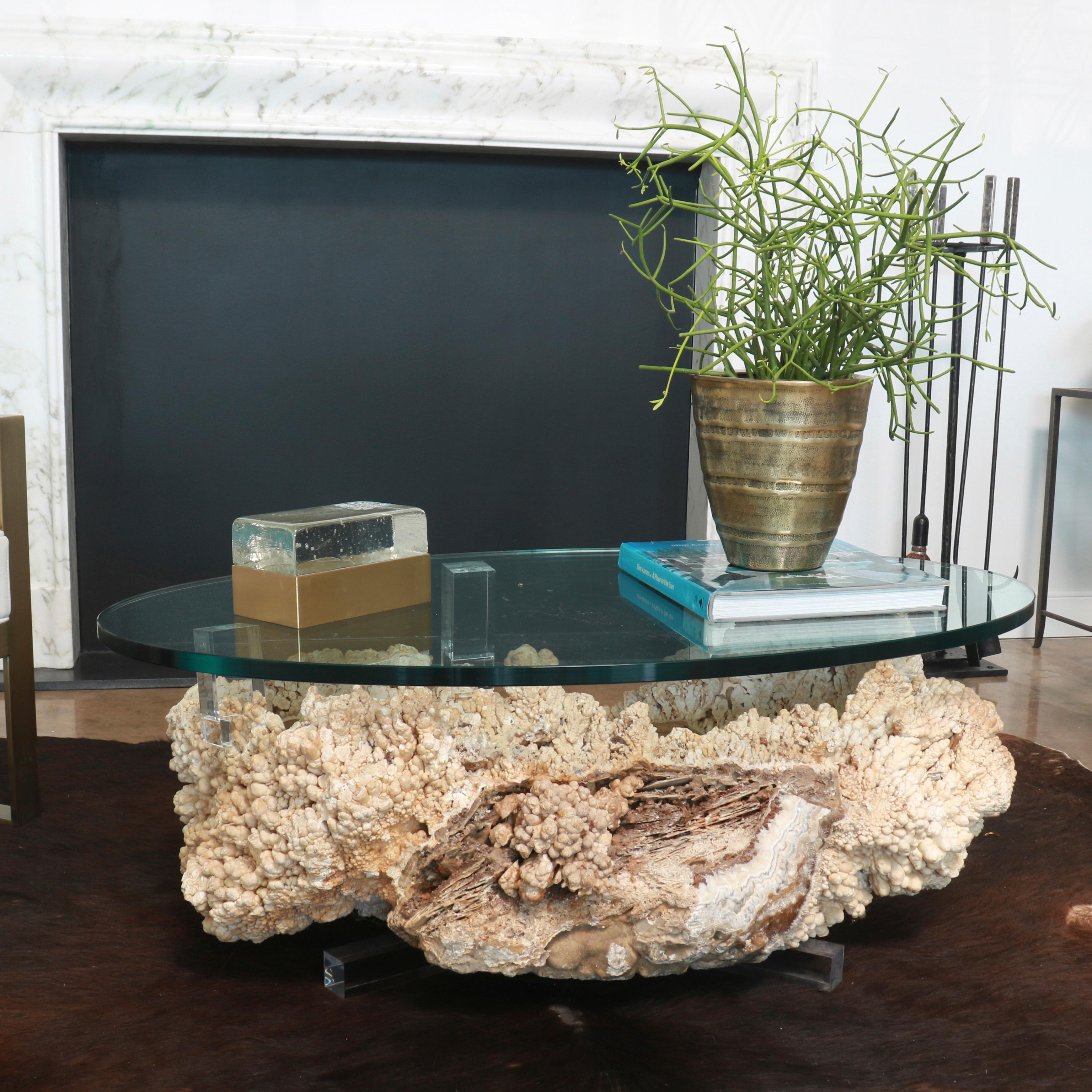 Our mineral and glass table is a unique piece of nature-born modern art. The glass top gives you the amazing view of the swirls inside a naturally formed mineral rock bowl, while providing a stable and sturdy surface to rest your drink or tablet.