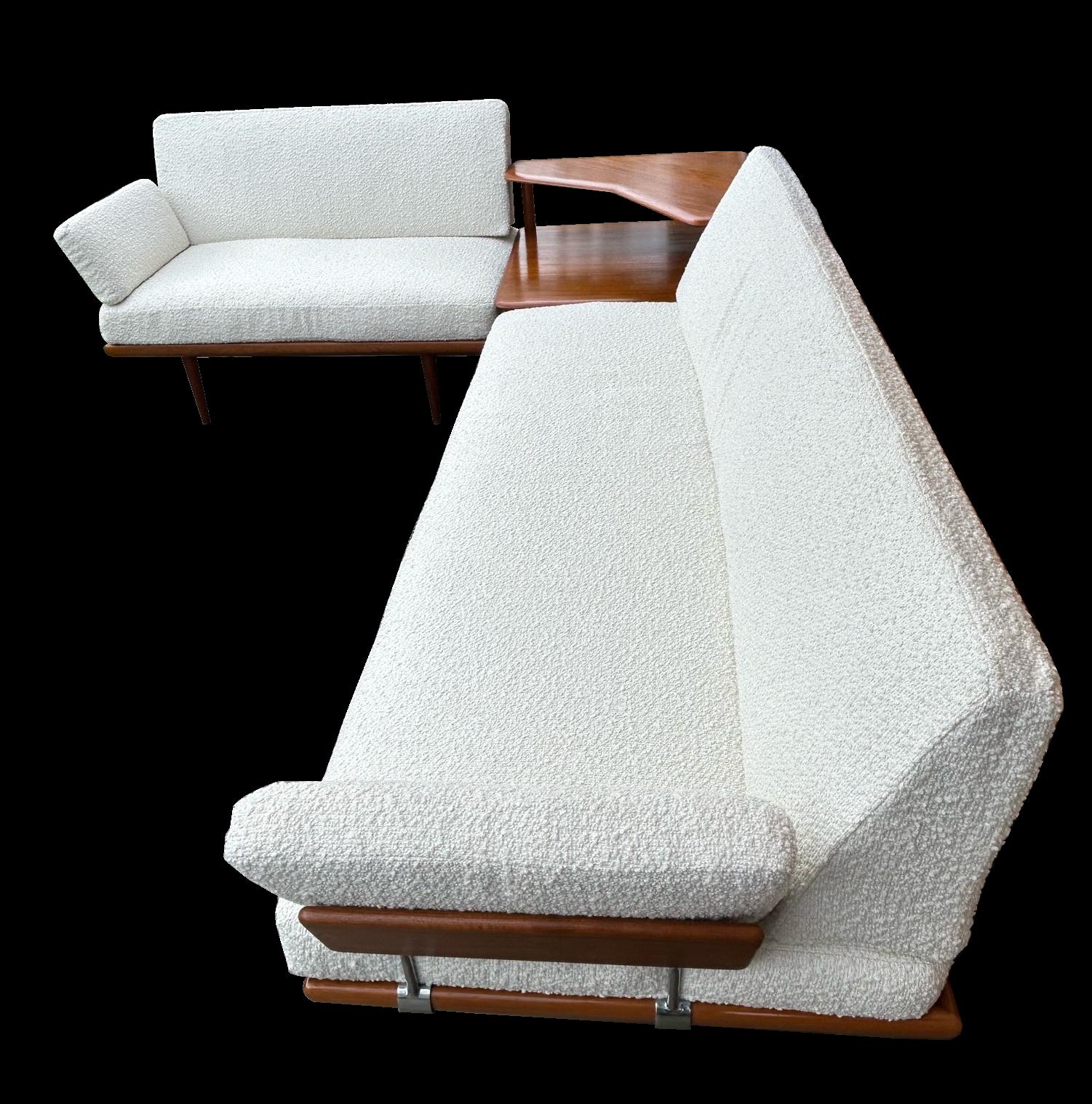 This is a classic original corner suite consisting of a three seat sofa, and a two seat sofa with matching corner two tier table. All produced in finest quality Teak with freshly reupholstered white boucle cushions.
Sizes of the 3-seater sofa: W.