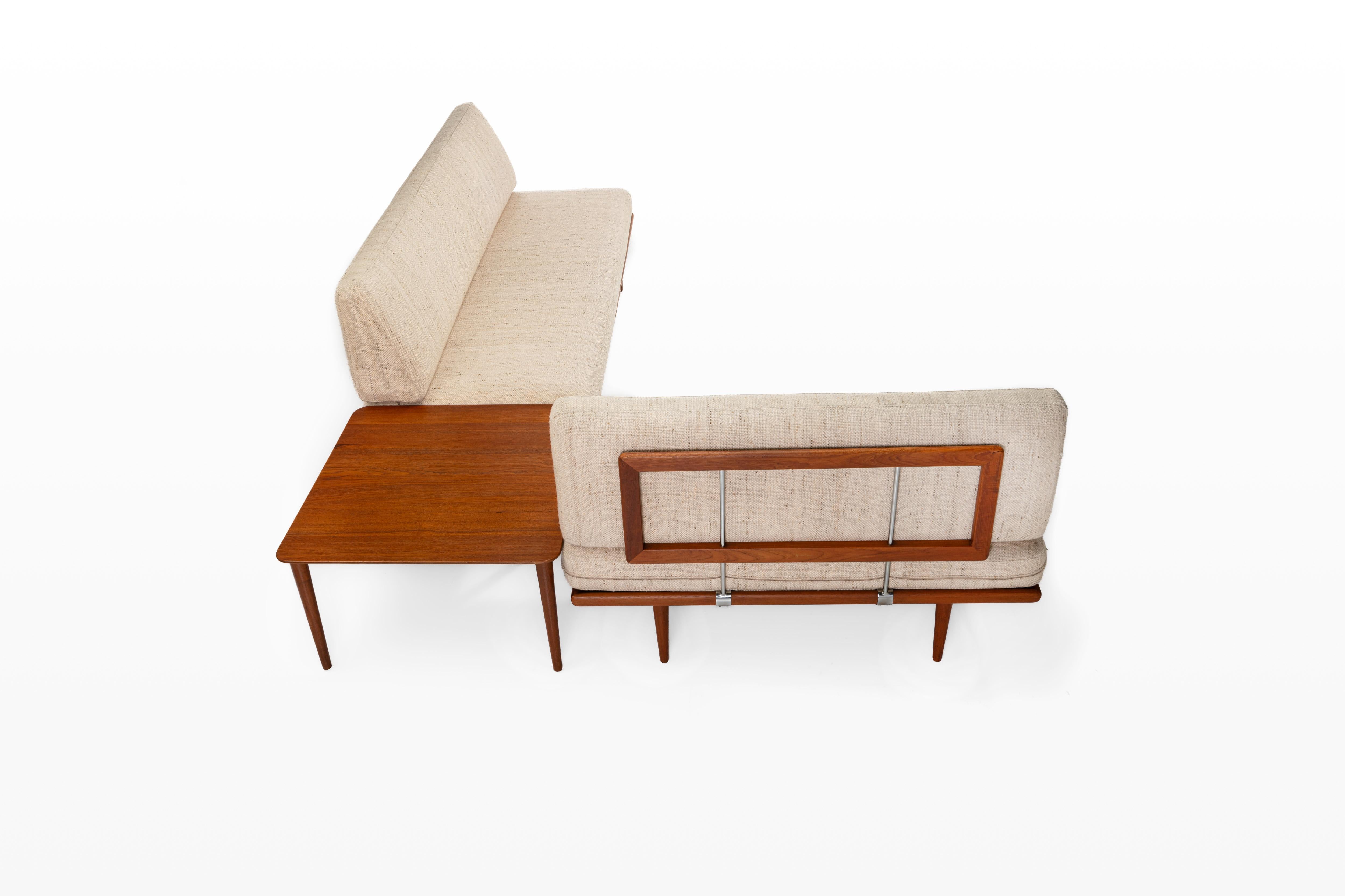 A stunning Minerva seating group designed by Peter Hvidt and Orla Mølgaard Nielsen for France & Daverkosen. The set includes a teak corner coffee table and three seater sofa and a two seater sofa.
Fabric is in vintage condition, see