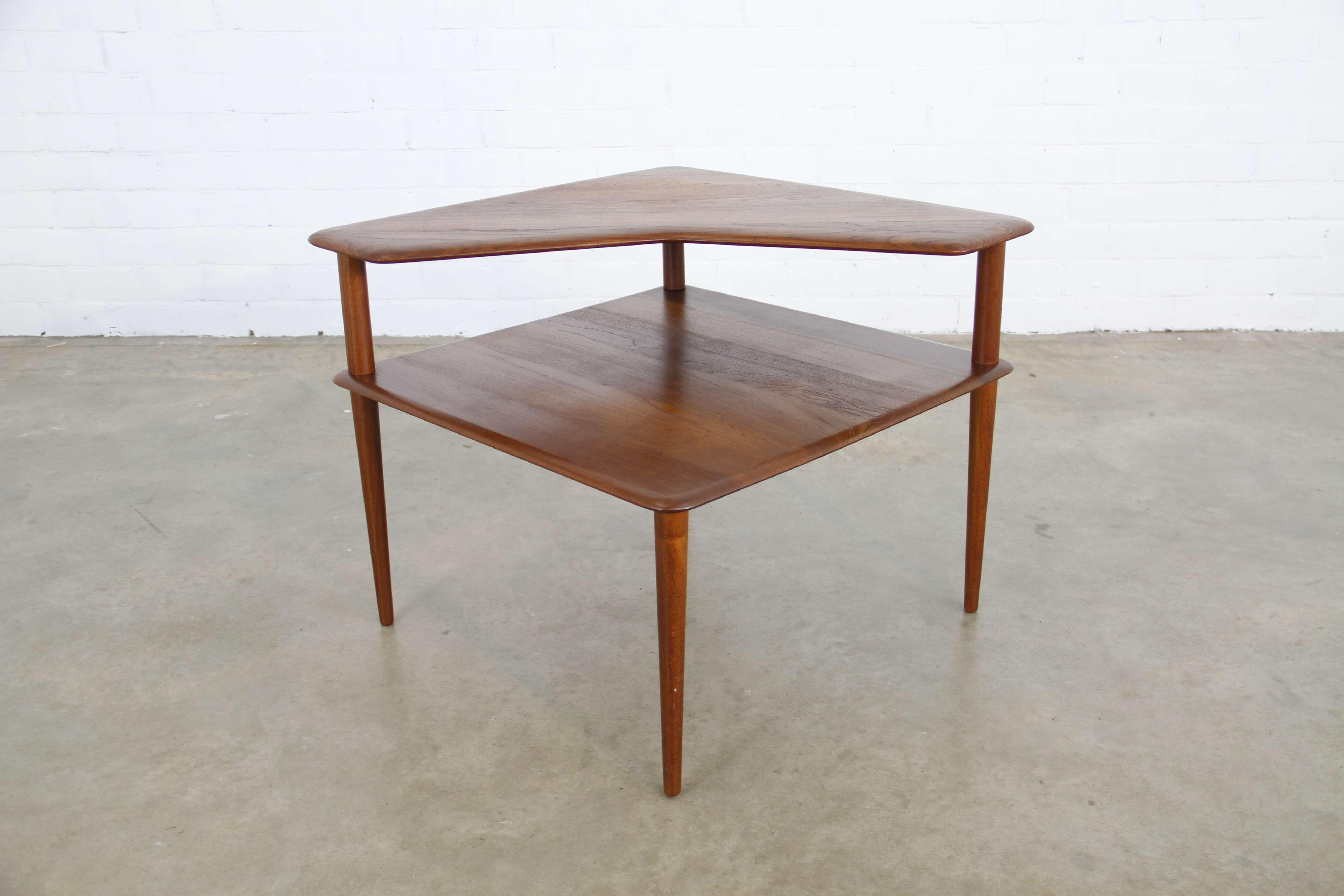 This side table in the shape of a rectangle was designed by Peter Hvidt & Orla Mølgaard-Nielsen in 1961. It is made by France & Son and has a teak frame.
 