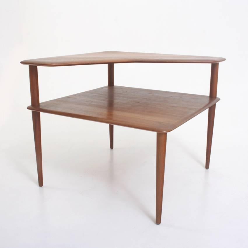Rectangular side table on thin conical legs with two tiers. Peter Hvidt & Orla Mølgaard-Nielsen designed the “Minerva” table for France & Son in 1957. Label and stamp of France & Son at the bottom.