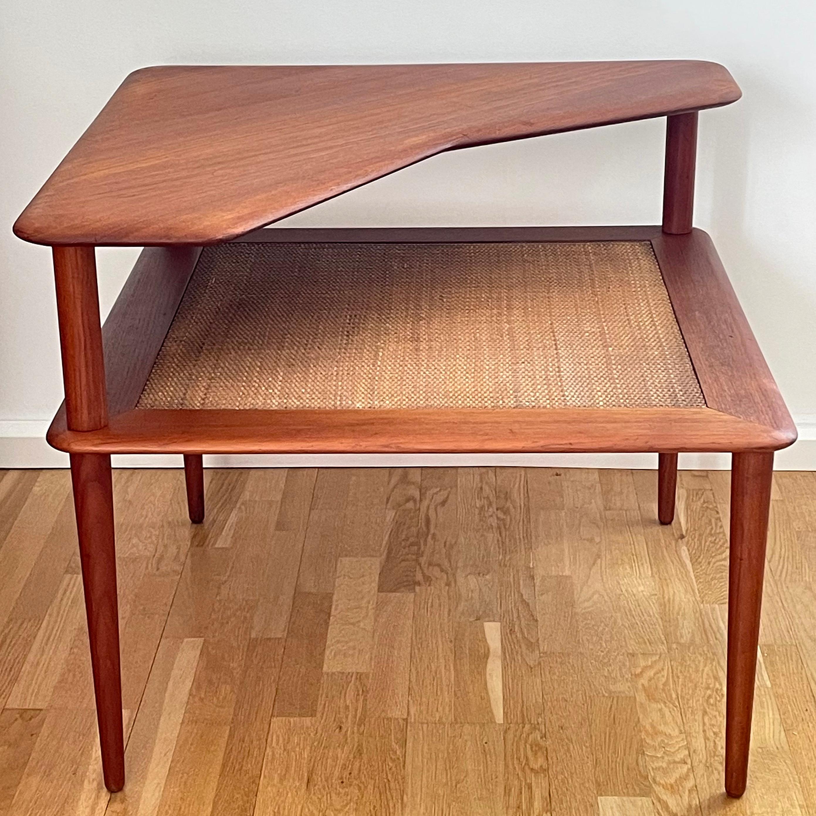 Two tiers side table on conical legs and where all teak are solid. Closed woven cane webbing. Designed by Peter Hvidt & Orla Mølgaard-Nielsen for France & Son.
This table will be shipped disassembled.