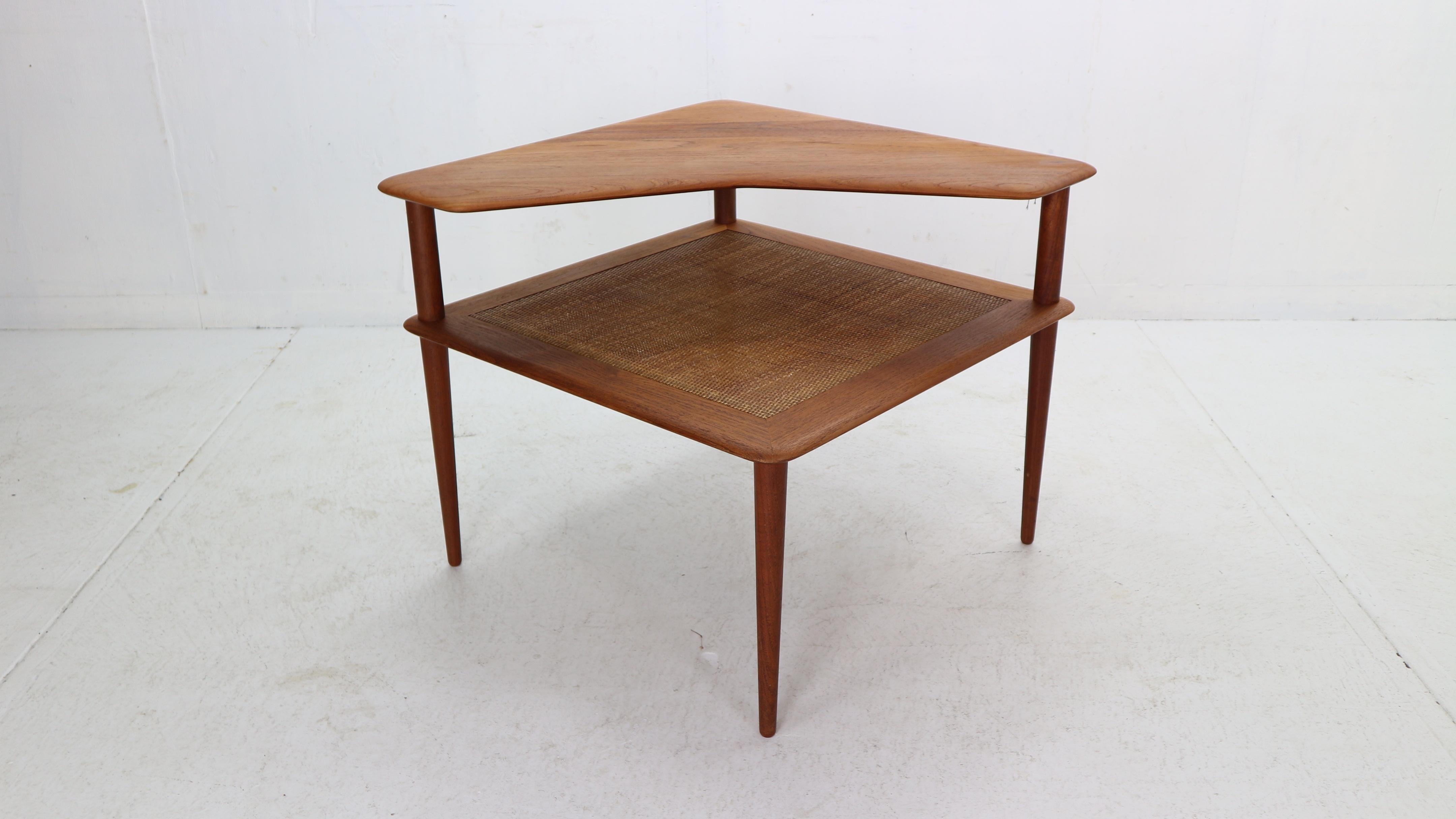 Beautiful side or corner table designed by Peter Hvidt & Orla Mølgaard-Nielsen for France & Son in 1961 Denmark. 
The table consists of two table tops, the upper one is beautifully shaped and made of solid teak, the lower one is made of closed