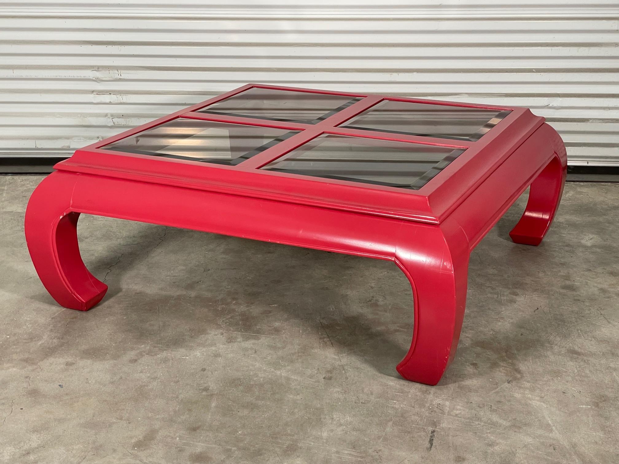 Ming Asian style coffee table features smoked beveled glass inserts and red high gloss lacquer finish. Good condition with minor imperfections to the newly lacquered finish. May exhibit scuffs, marks, or wear, see photos for details.
Shipping to