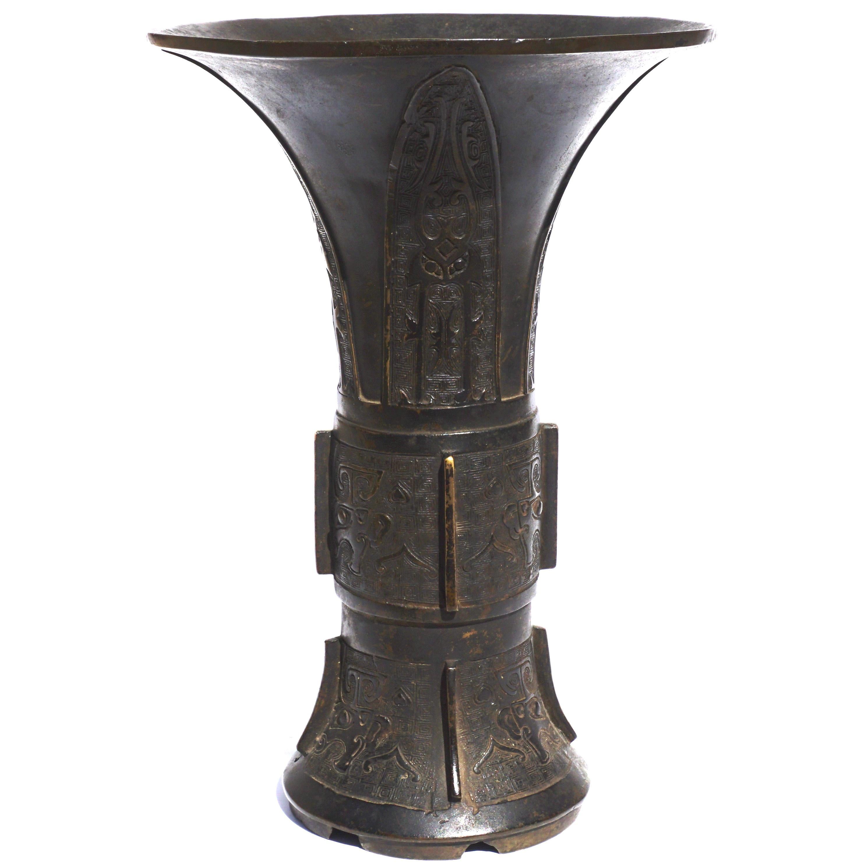 Chinese bronze vase, Gu, the trumpet-shaped upper section cast with four blades filled with archaic designs. Center and lower sections depicting Toadies with very intricate backgrounds. With a nice old rich dark patina. Circa 17th century; Late Ming