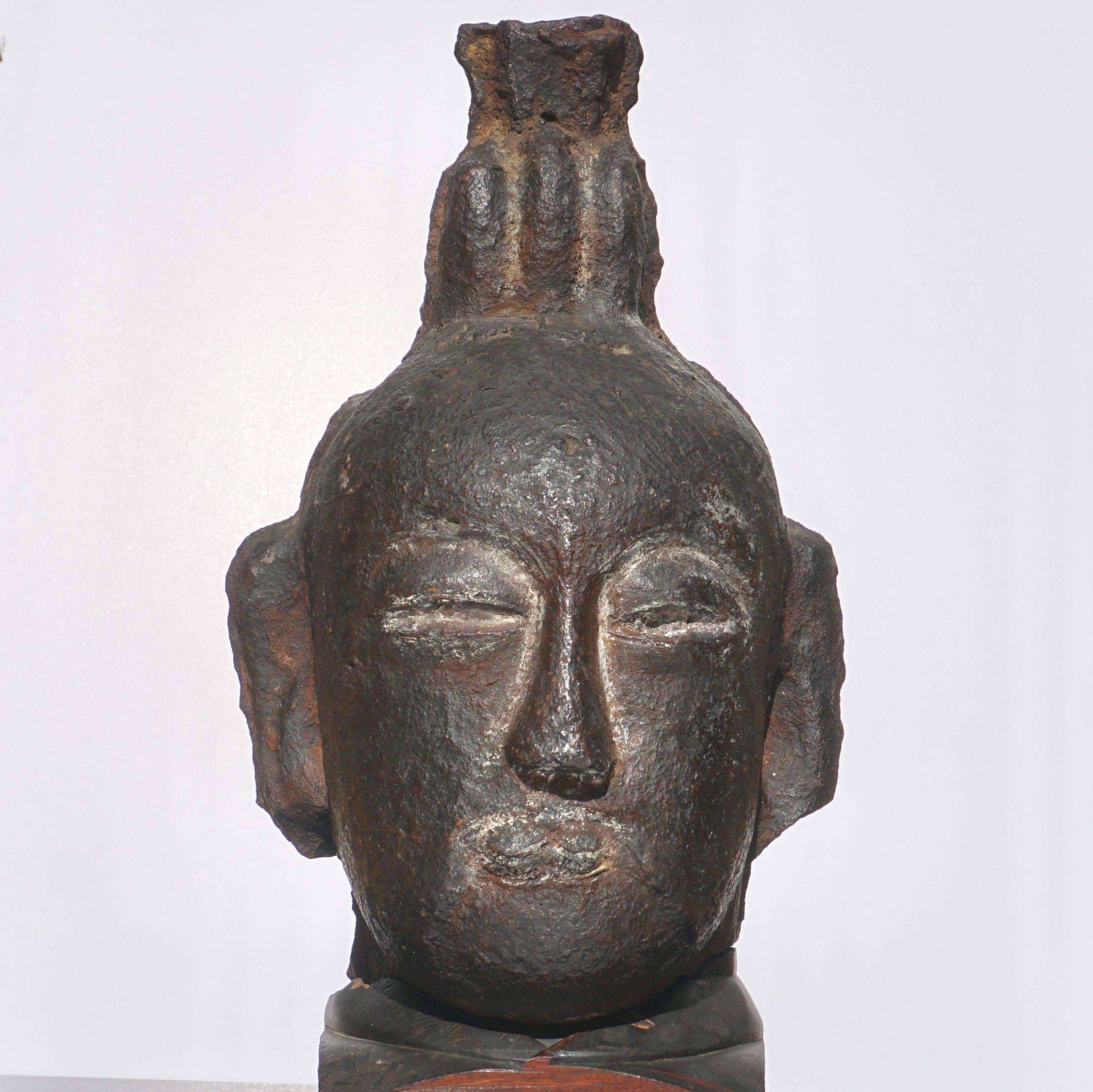 Daoist sage, official, or possibly a Buddhist acolyte.

A large, thick and heavy cast iron statue of a head. Custom vintage carved hardwood stand finishes off this outstanding and decorative bust, circa 10th - 14th century or earlier.

Measures: