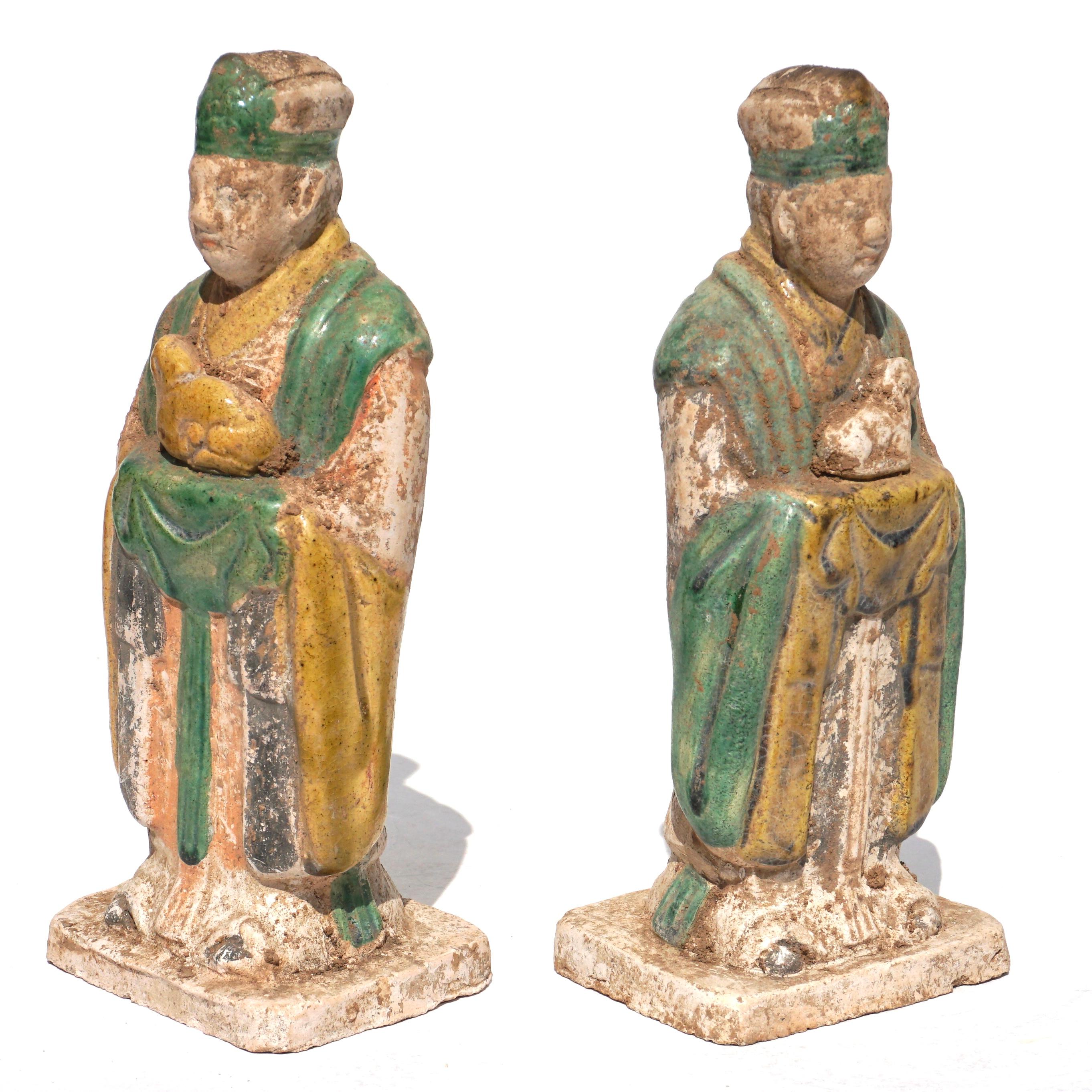Ca. 1368-1644 AD. Ming Dynasty. 

A fabulous set of two mould-made, glazed ceramic zodiac figures. Each wearing long draping gowns of rich green, yellow and orange hues. Each figure holding a an animal of the Chinese zodiac, a rabbit and a sheep in