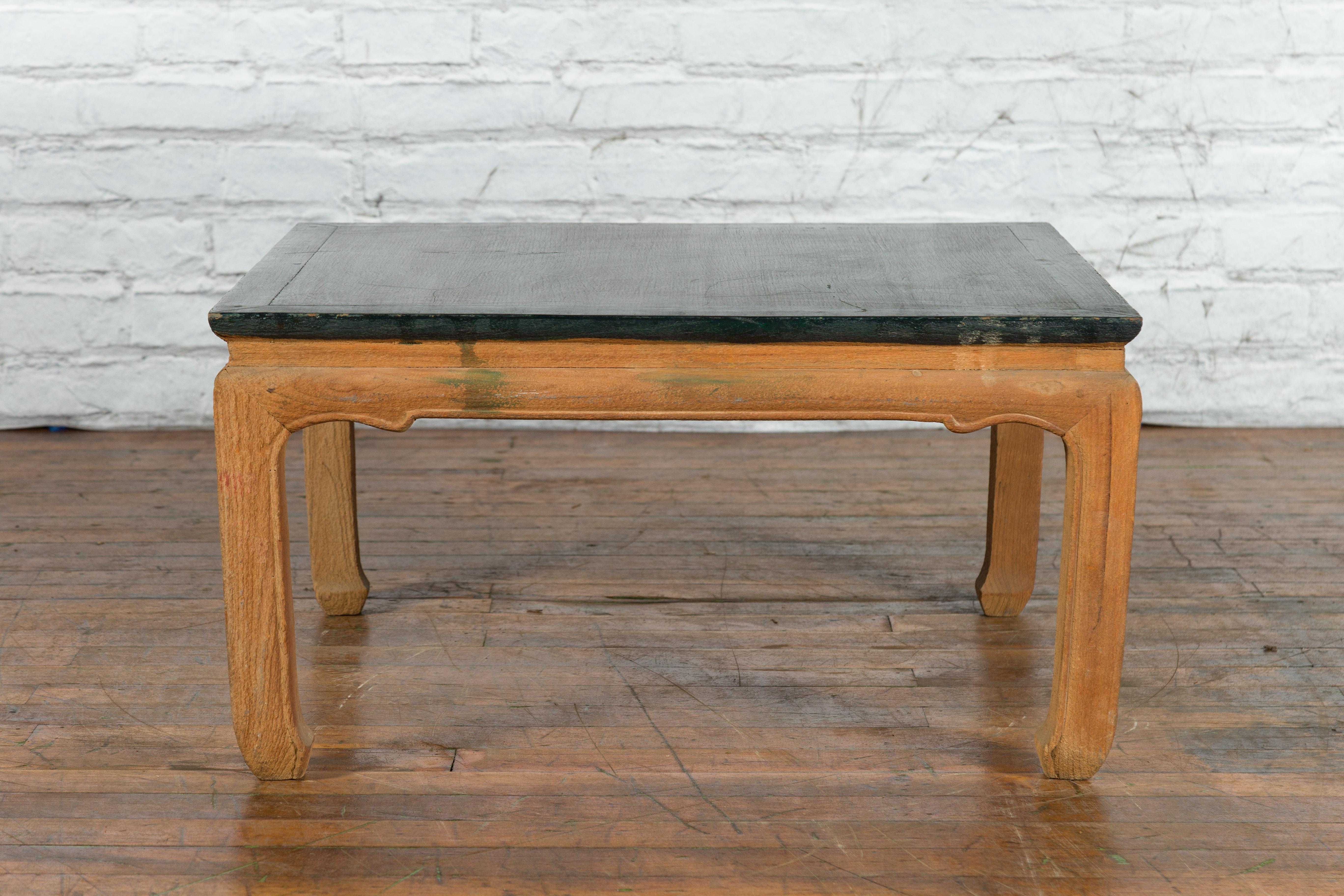 A vintage Chinese Ming Dynasty style low square-shaped coffee table from the mid 20th century with green lacquer top and horse hoof legs. Created in China during the Midcentury period, this Ming style table features a dark green lacquered top with