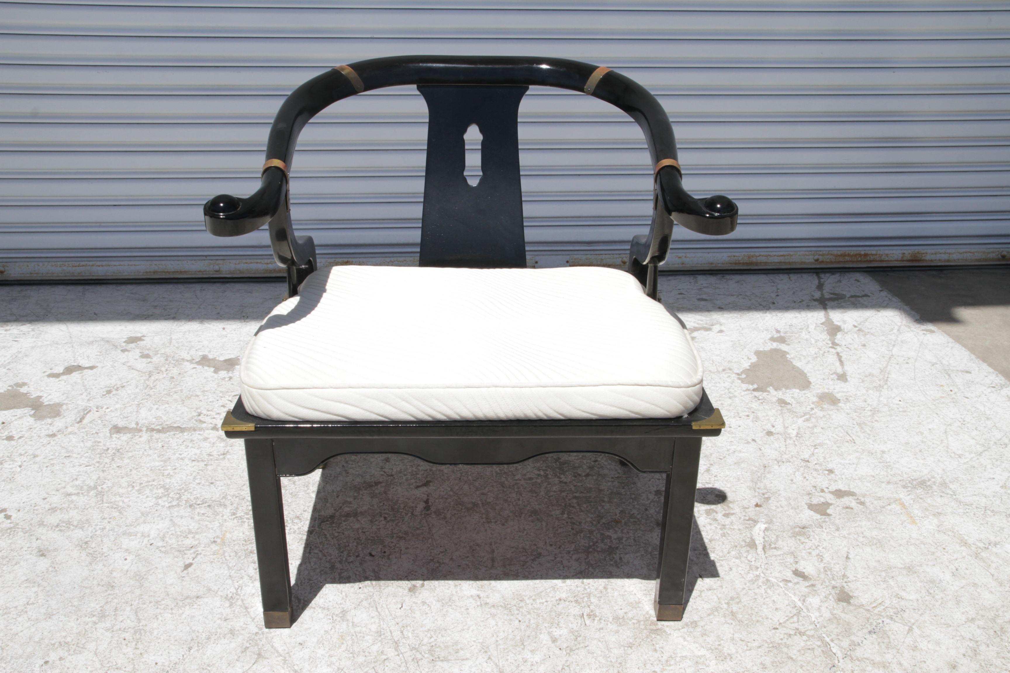 Il s'agit d'une chaise de salon à dossier en fer à cheval laqué noir d'inspiration asiatique, avec des accents et des bandes en laiton qui ornent la pièce. La chaise est joliment recouverte d'un élégant tissu blanc. 

Dimensions :
Longueur :