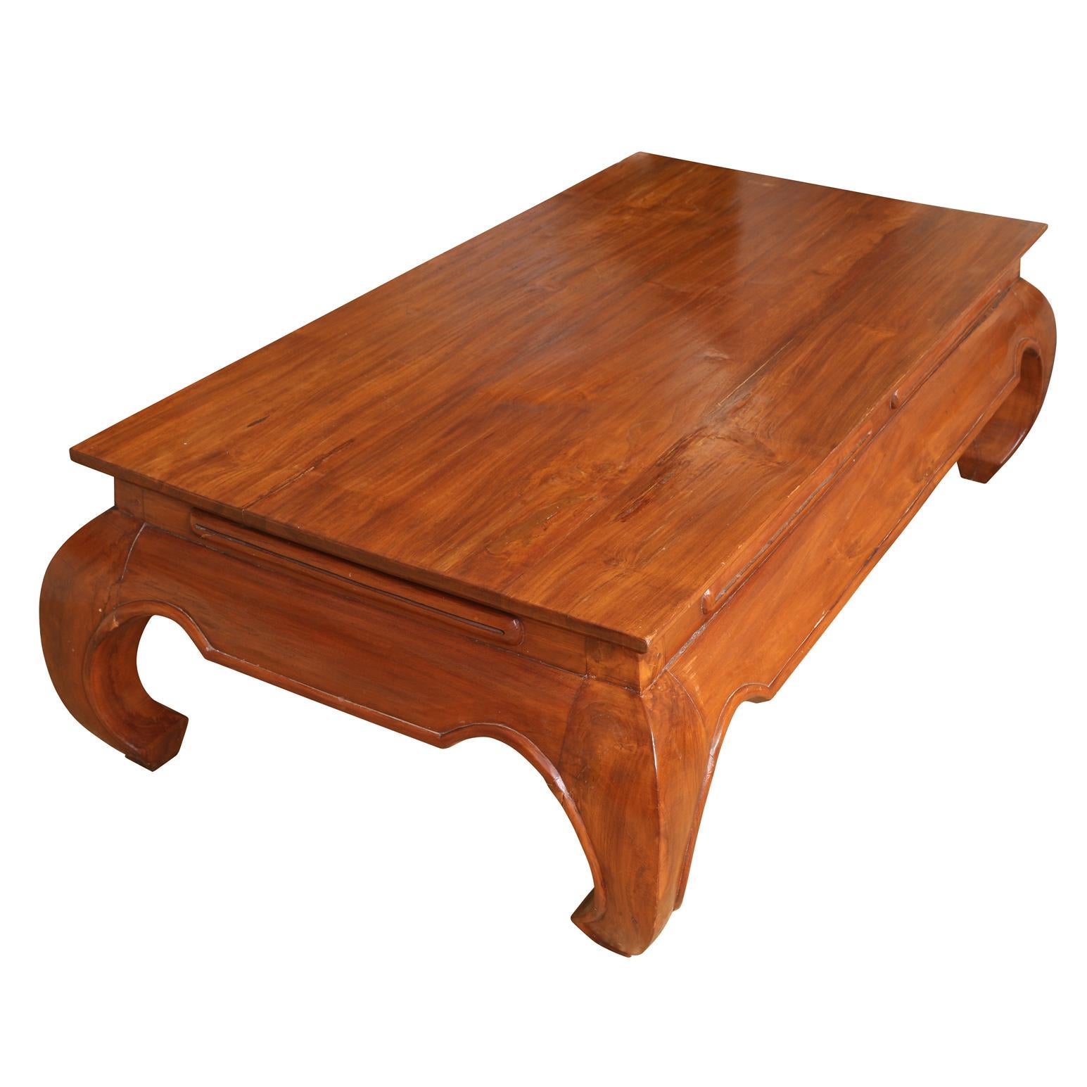 An Indonesian teak coffee table in Asian Ming style with curved legs.
