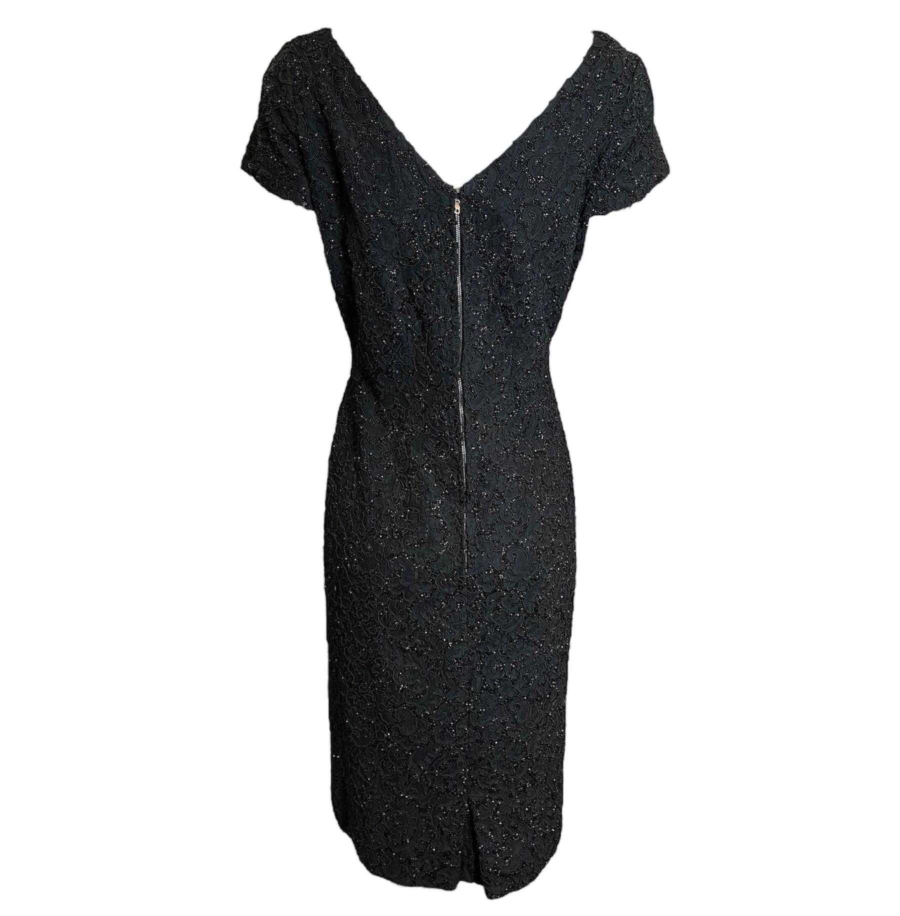 This Mingolini Gugenheim black beaded dress is a rare, Italian couture piece that displays impeccable attention to detail and expert craftsmanship. From the late 50s/early 60s, it features a heavily beaded design over corded lace and is fully lined.