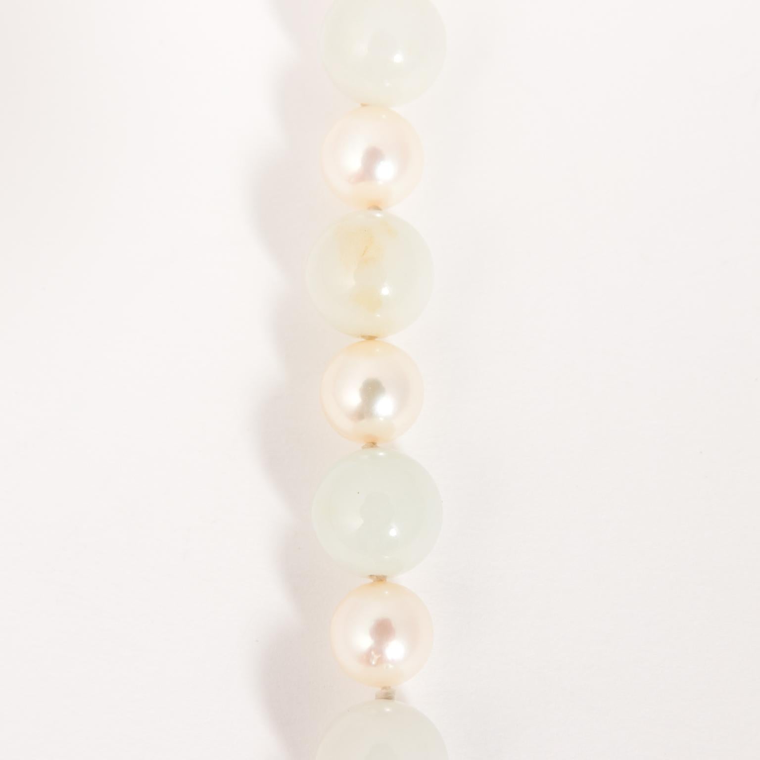 Nice vintage high quality Ming's Jadeite Jade necklace in shades of rice cake and pale green. There is a luscious cultured pearl in between each jade bead. Jade beads are 10 - 8.5 mm and pears are 7.5 - 7 mm. Total length is 30 inches. The clasp is
