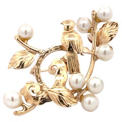 Broche oiseau des singes sur une perle prune en or jaune 14 carats