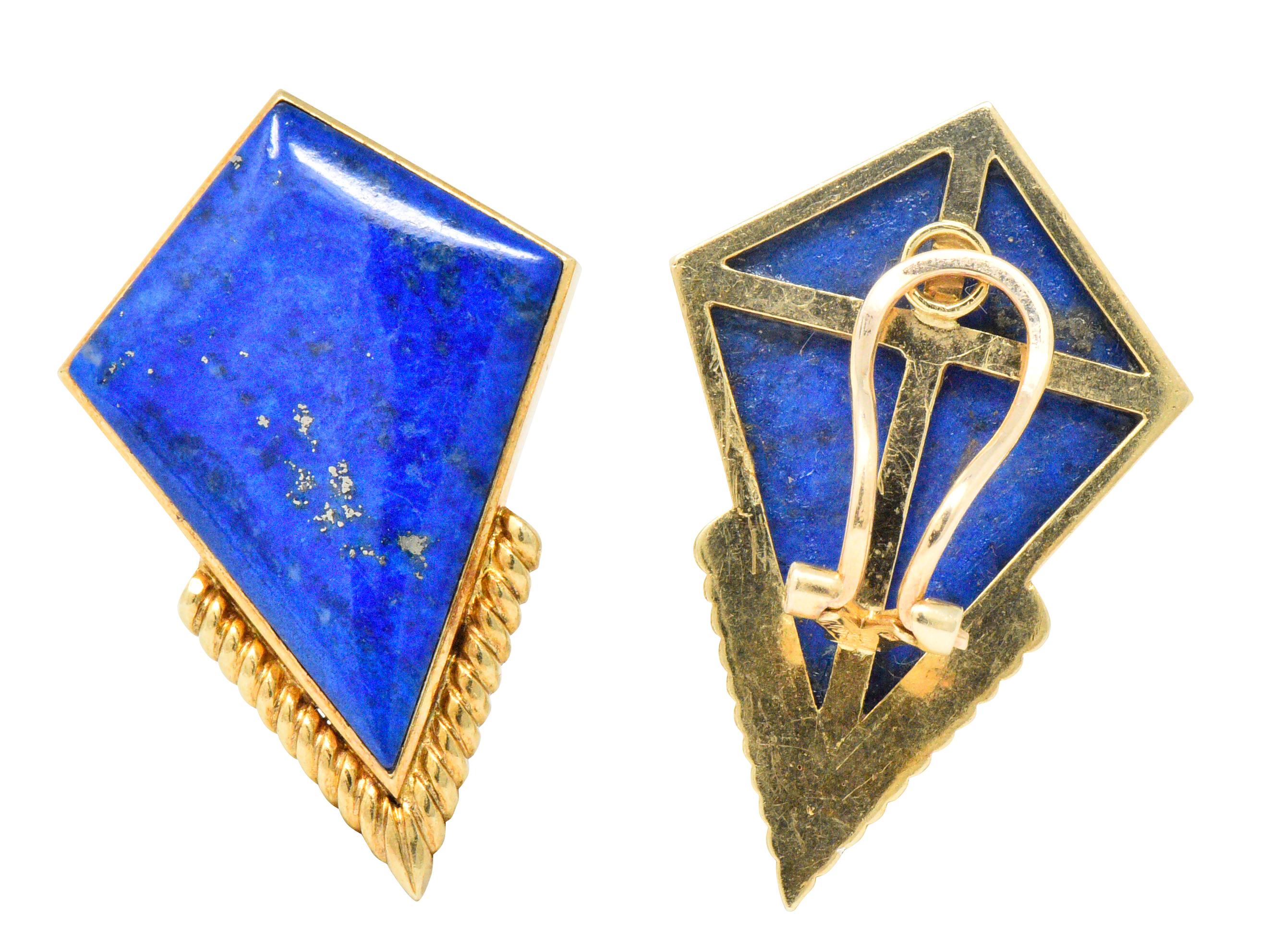 Shield contains polished lapis lazuli, bright blue with some dark blue veining and flecks of pyrite

Accented with polished fluted gold

Bright bold statement ear-clips 

Fully signed Ming's with hinged omega backs

Measures: Approx. 1 1/2 x 1