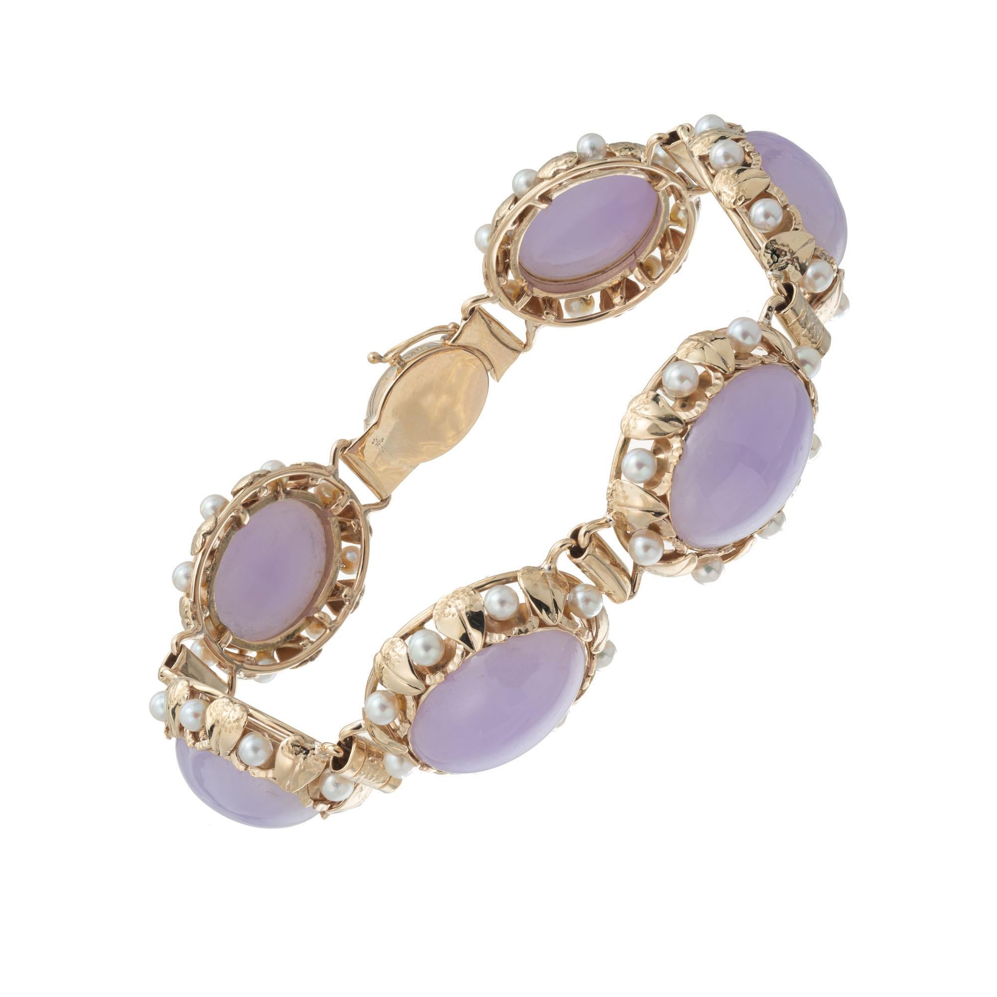 Jade and pearl link bracelet. GIA Certified natural untreated purple translucent jadeite jade bracelet accented with 48 cultured white grey pearls in 14k yellow gold. Signed Mings. 8 inches in length. 

6 oval cabochon purple jade, GIA Certificate #