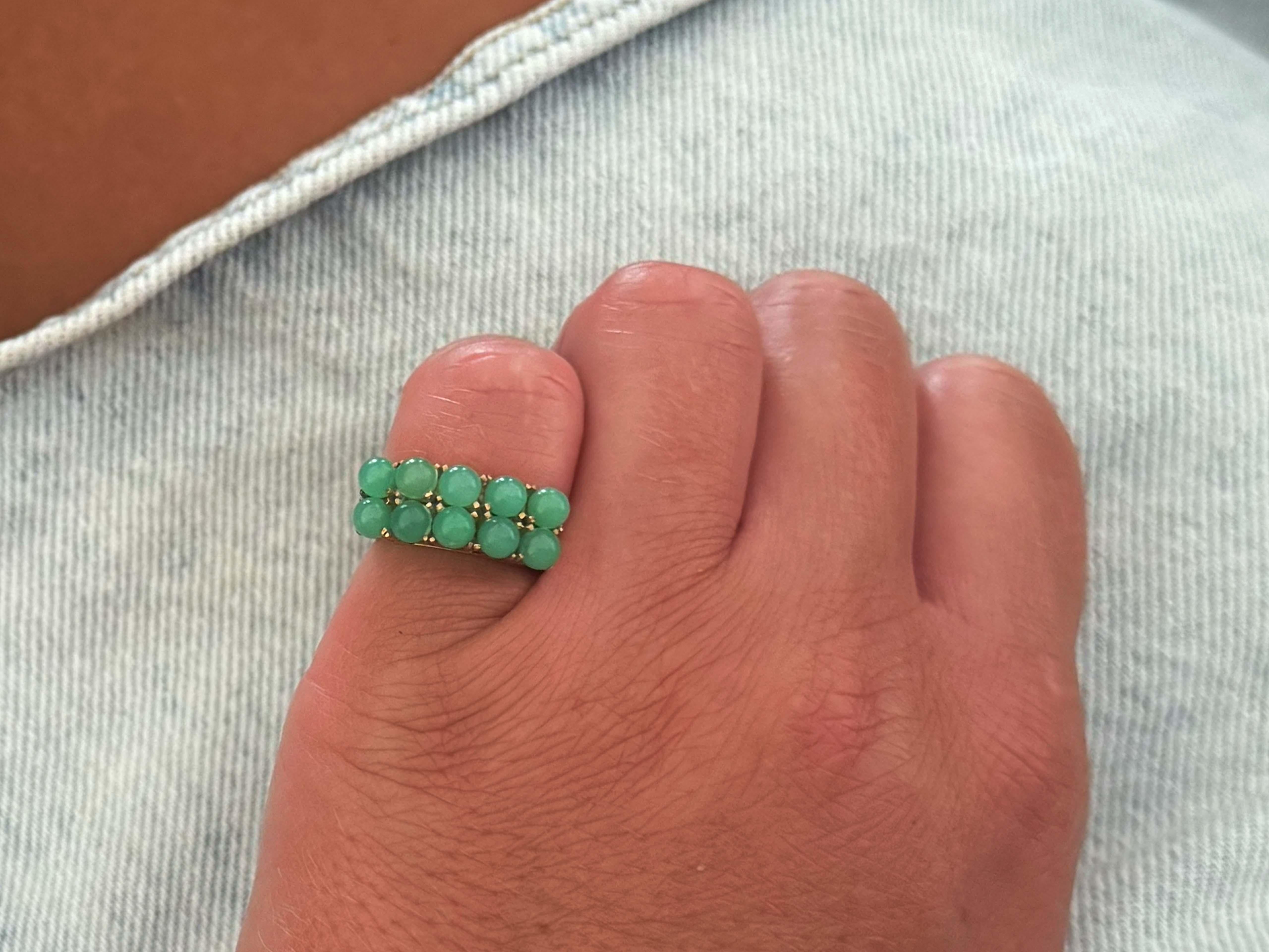 Specifications:

Designer: Ming's Hawaii

Metal: 14k Yellow Gold

Jade Info: 10 round green jade spheres

Jade Diameter: ~3.9 mm 

Jade Carat Weight: ~4.20 carats

Total Weight: 5.2 Grams

Ring Size: 5 (resizable)

Stamped: 