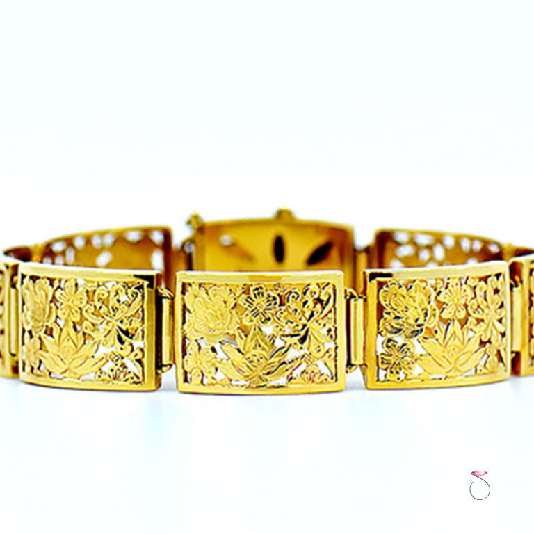 A magnificent Ming's Hawaii sectional bracelet in 14k yellow gold. The cut out design of the highly desirable four seasons pattern is just stunning featuring different season blossoms. This bracelet containes 8 hinged sections including the clasp,