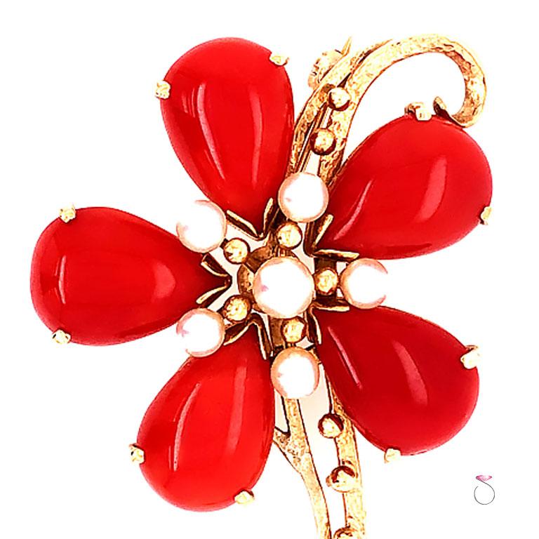 Gorgeous Ming's red Coral & white Akoya Pearl flower brooch. The brooch features a large flower design of five pear shape red coral cabochon and 6 small round white pearls. Each Coral piece is prong set securely and measures approximately 15.50 mm x