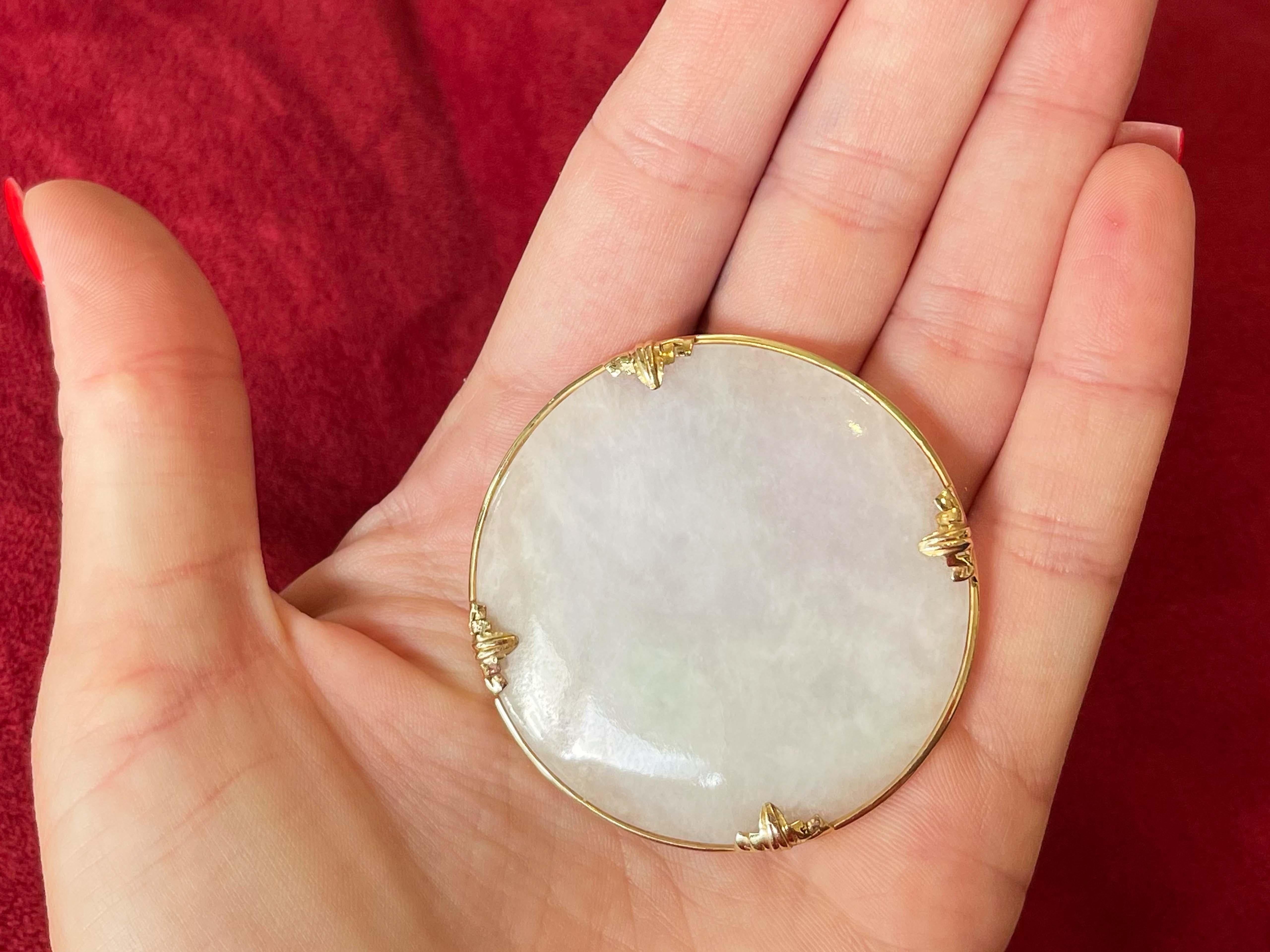 Brooch Specifications:

Designer: Ming's Hawaii

Metal: 14k Yellow Gold

Total Weight: 27.4 Grams

Stone: Natural White Jade 

Brooch Measurements: ~2