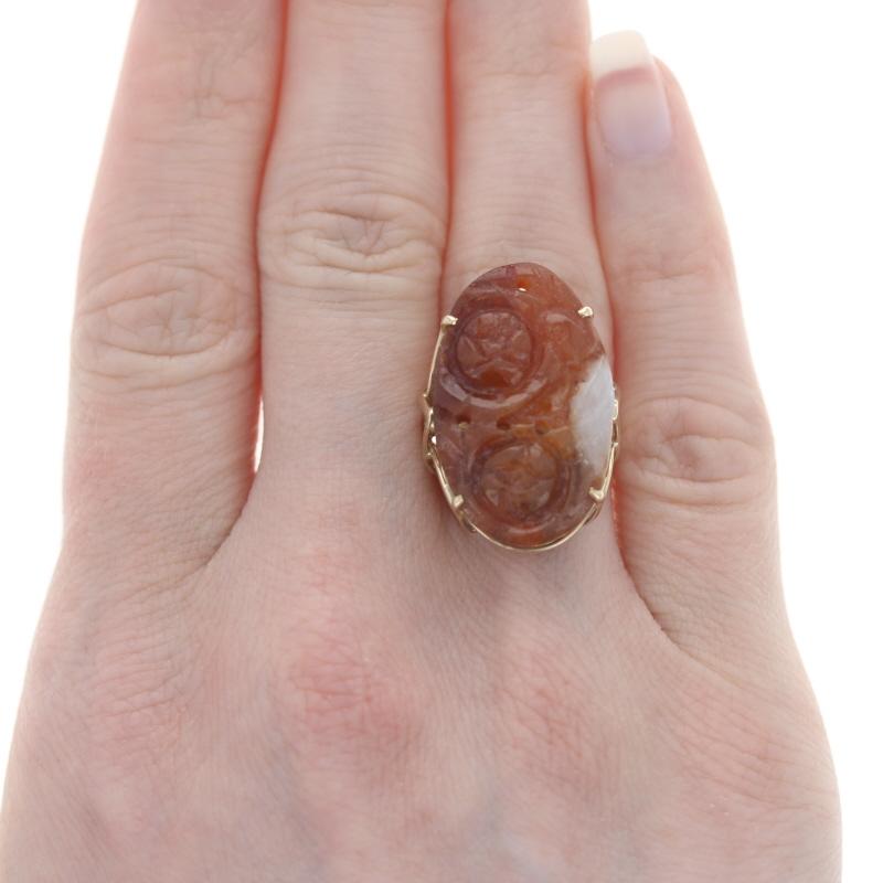 Size: 7 1/4
Sizing Fee: Down 1 for $40 or up 2 for $50

Brand: Ming's Honolulu

Era: Vintage

Metal Content: 14k Yellow Gold

Stone Information

Russet Jadeite
Treatment: Not Treated
Cut: Carved Floral
Color: Reddish Brown & White

Style: Cocktail