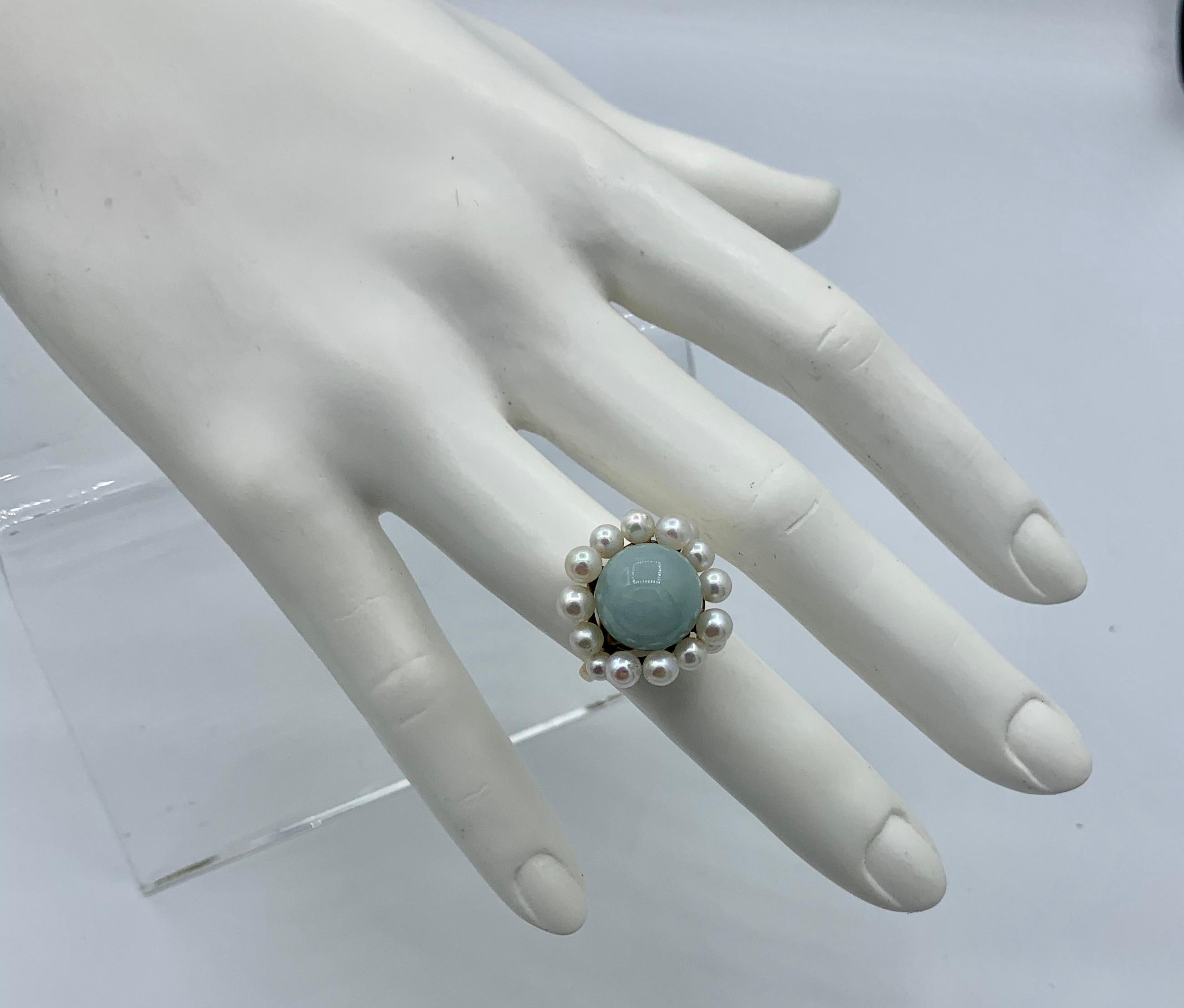 A rare Ming's Jade Ring with a fabulous Pearl Halo in 14 Karat Gold.  The vintage Ming's of Hawaii jade and pearl ring is just exquisite.  The color of the Jade cabochon surrounded by the beautiful white pearls in an undulating design around the
