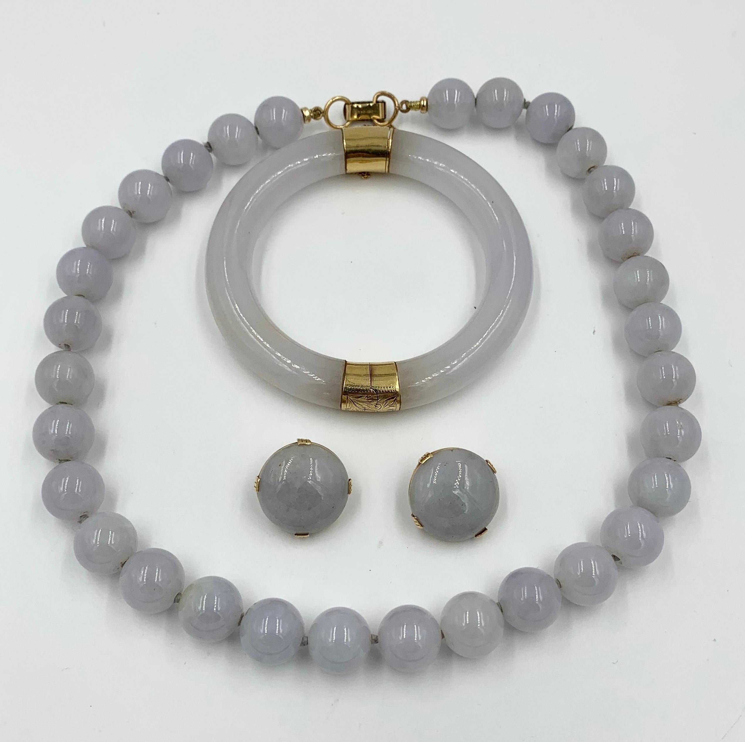 A spectacular and rare Ming's Lavender Jade Suite.   The suite comprising a necklace, earrings and bangle bracelet.  The highly coveted Ming's jade jewelry of Hawaii is becoming exceedingly difficult to find.   And here we have a suite.

Bangle