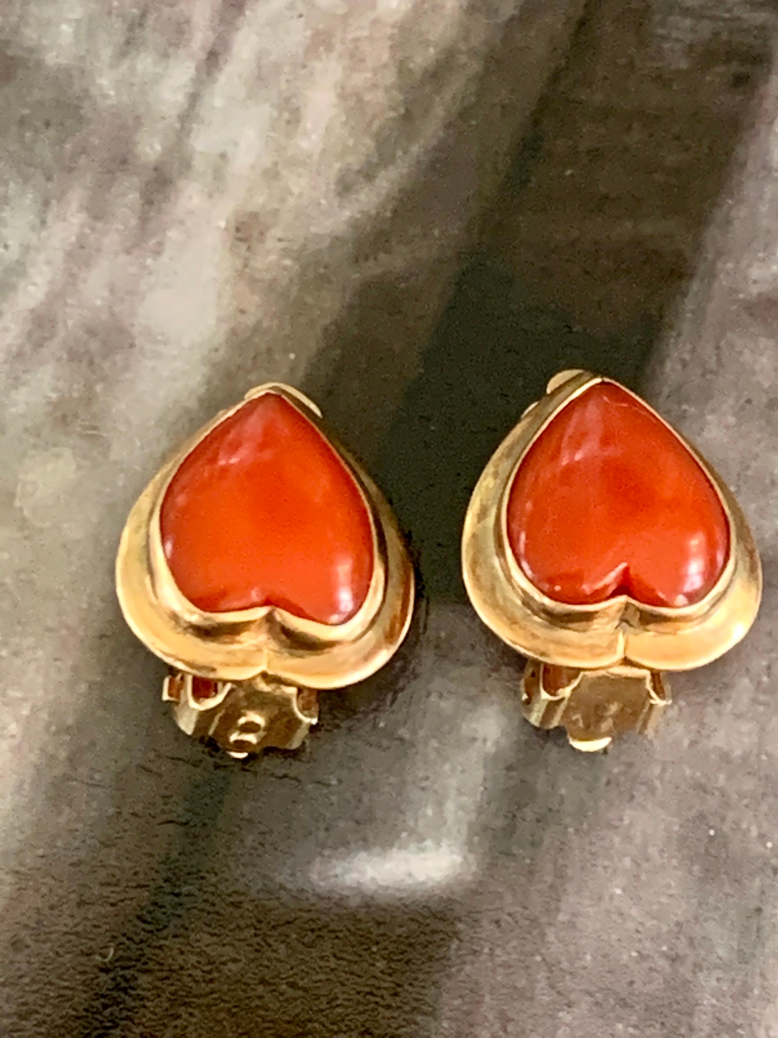 These lovely earrings, made by Ming's of Honolulu, feature an Oxblood Coral heart-shaped cabochon stone set in 14 karat yellow Gold.  They are .6